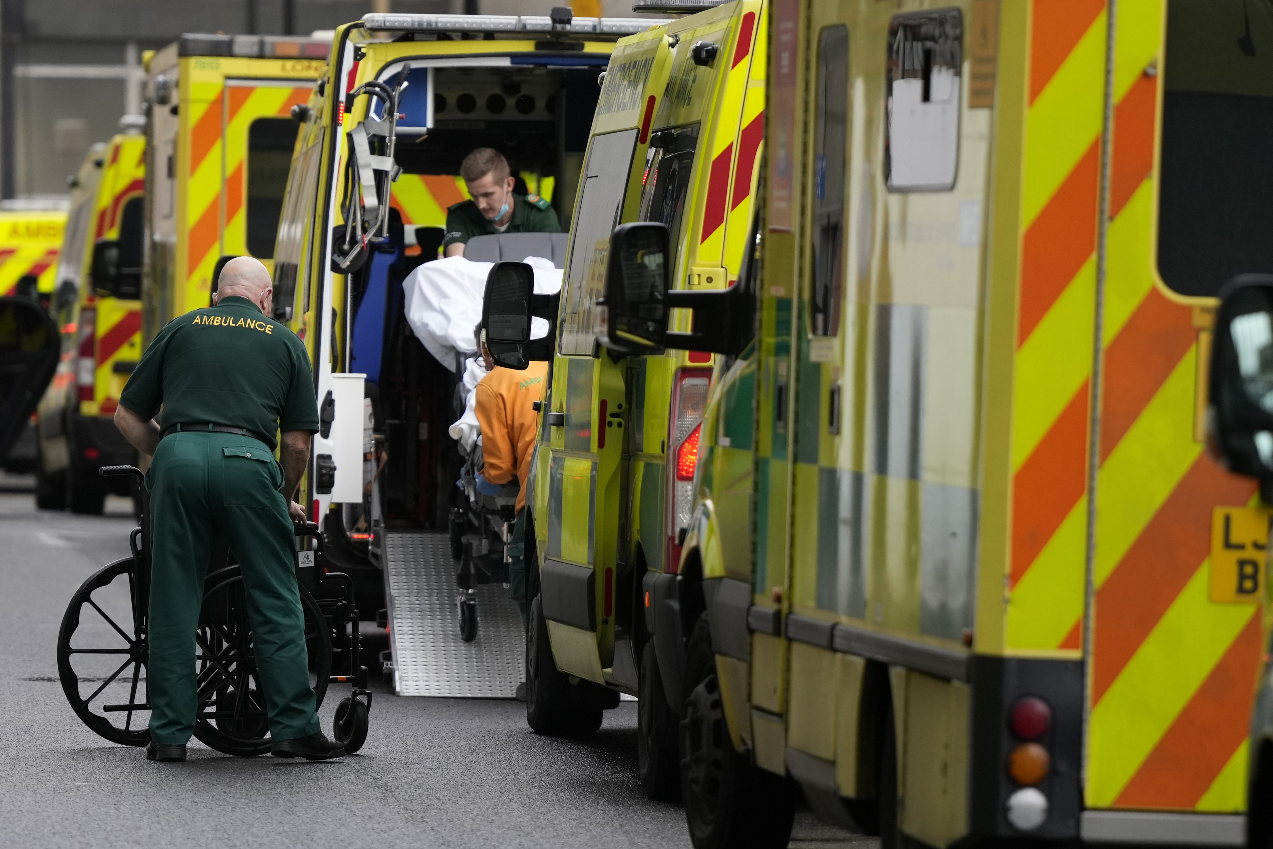 A patient is taken in to an ambulance as other ambulances wait outside the Royal London Hospital in east London