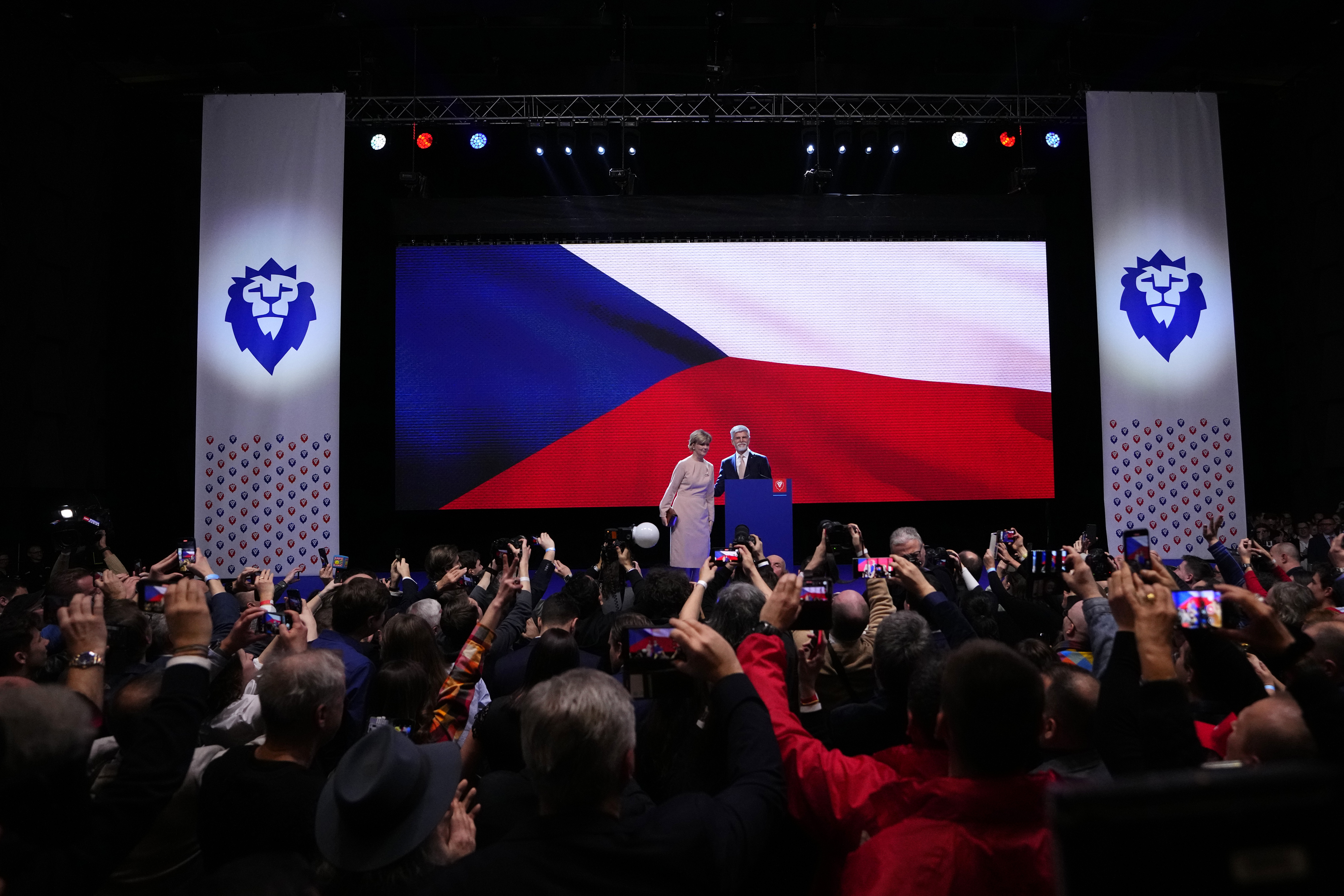 Czech Republic's President elect Petr Pavel with his wife Eva addresses his supporters after announcement of the preliminary results of the presidential runoff in Prague, Czech Republic, Saturday, Jan. 28, 2023. (AP Photo/Petr David Josek)