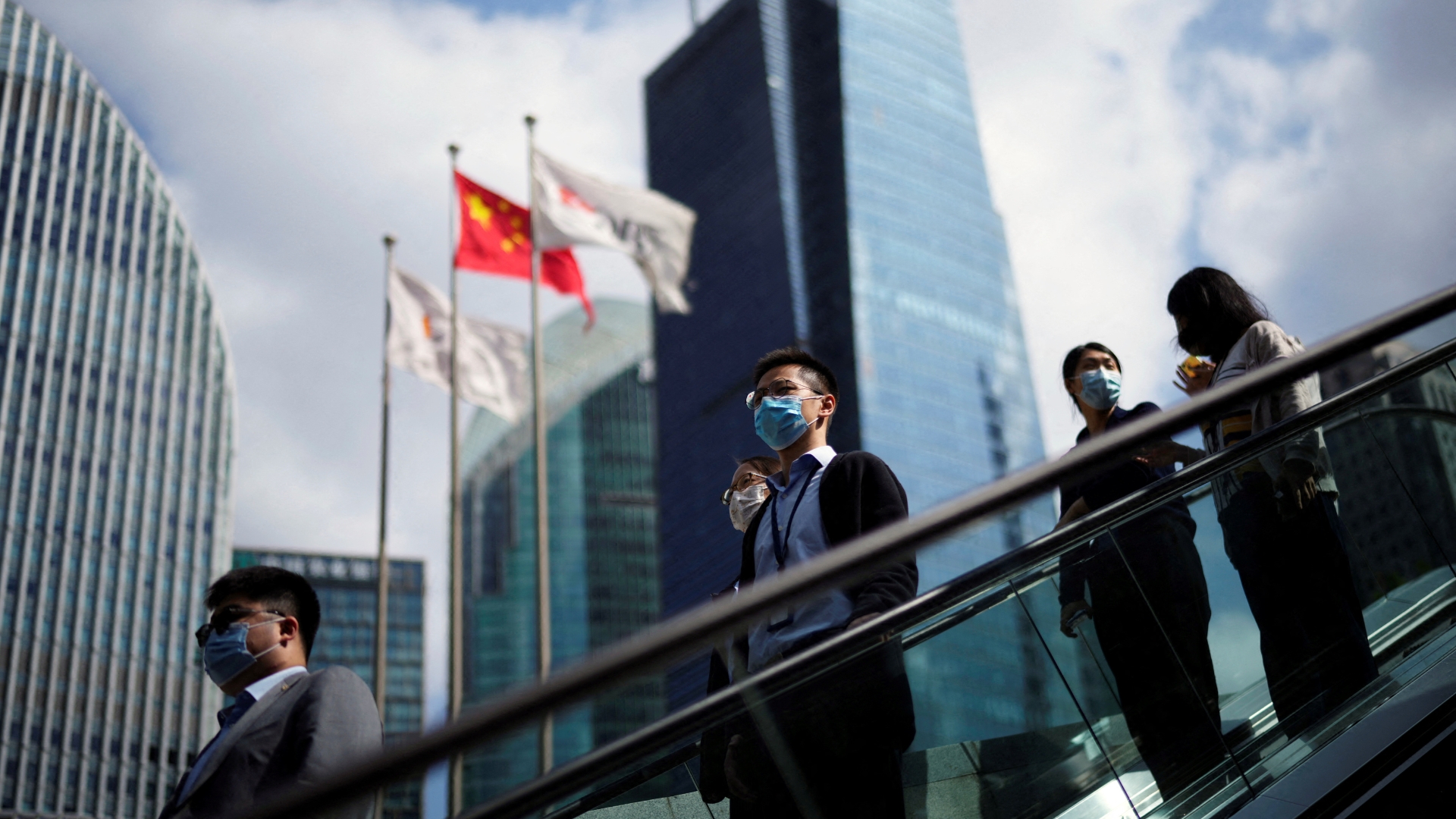 People stand on an escalator in China