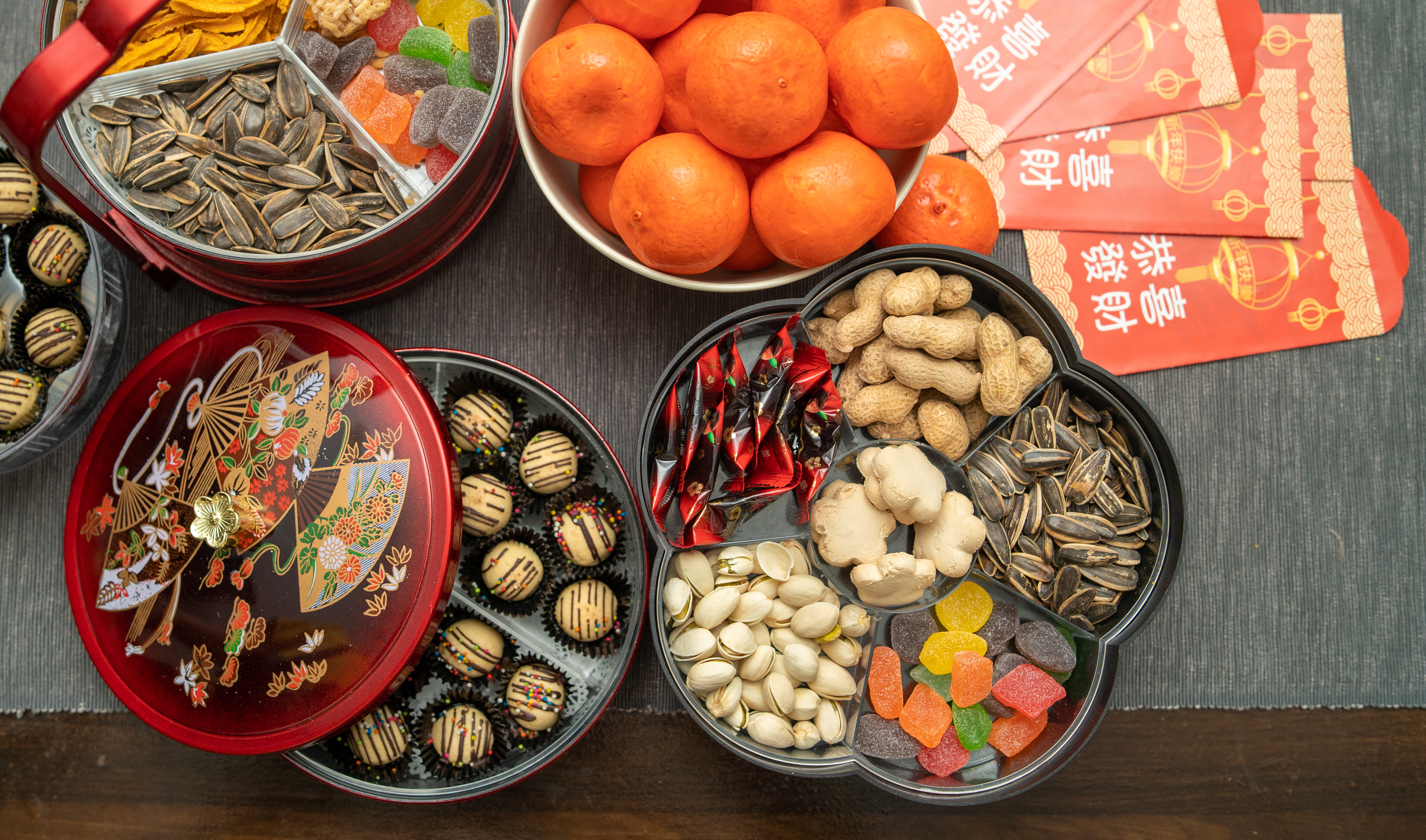Overhead shot of a table laden with sweets and snacks for Chinese New Year