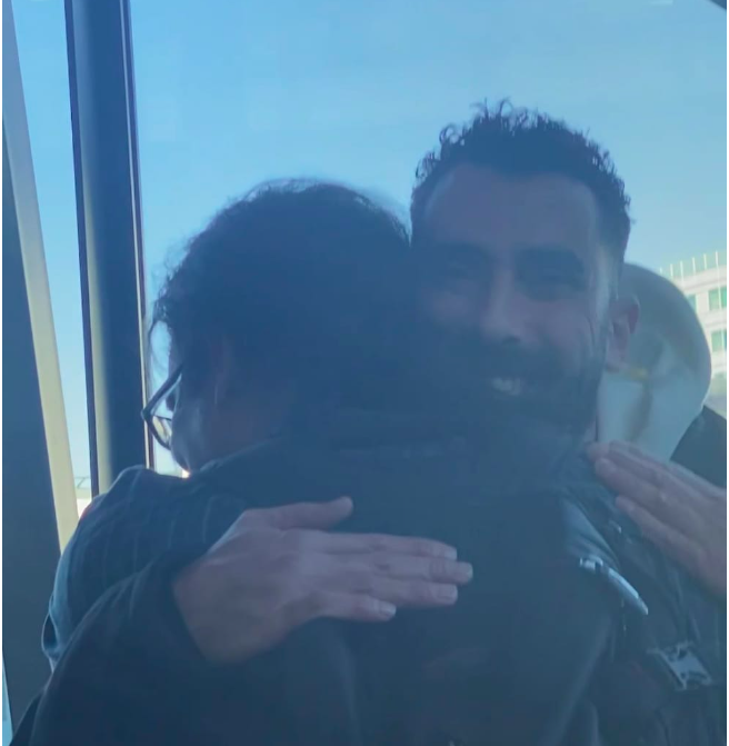 Sammy (L) and Laurent (R) hug each other at of Lyon’s Saint Exupéry airport. [Courtesy of Emmanuelle Alifar] 