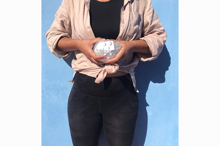 A photo of a person holding a blister pack of pills.