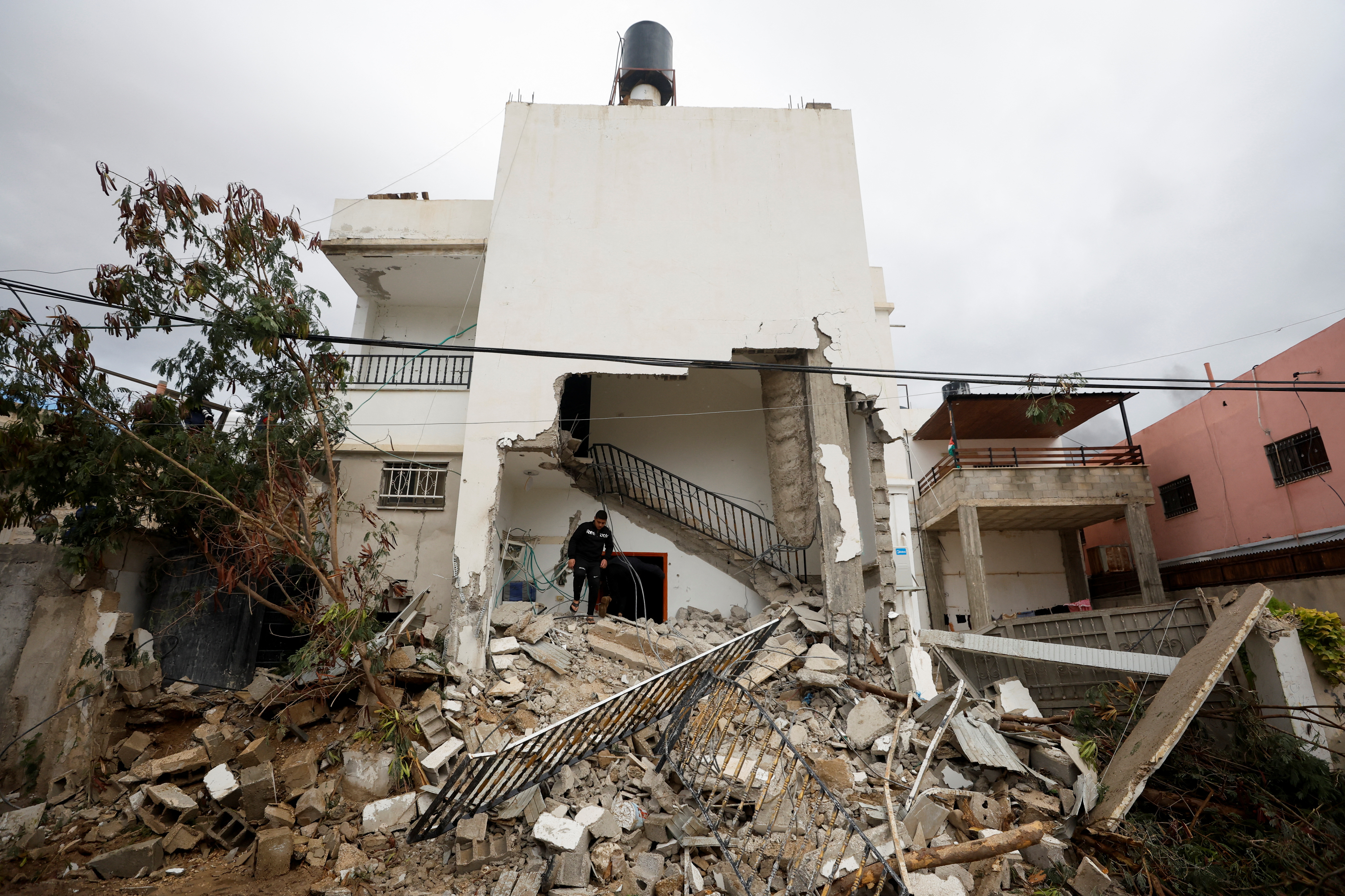 A Palestinian man checks damage in a house which was destroyed by Israeli troops during a military raid in Jericho.