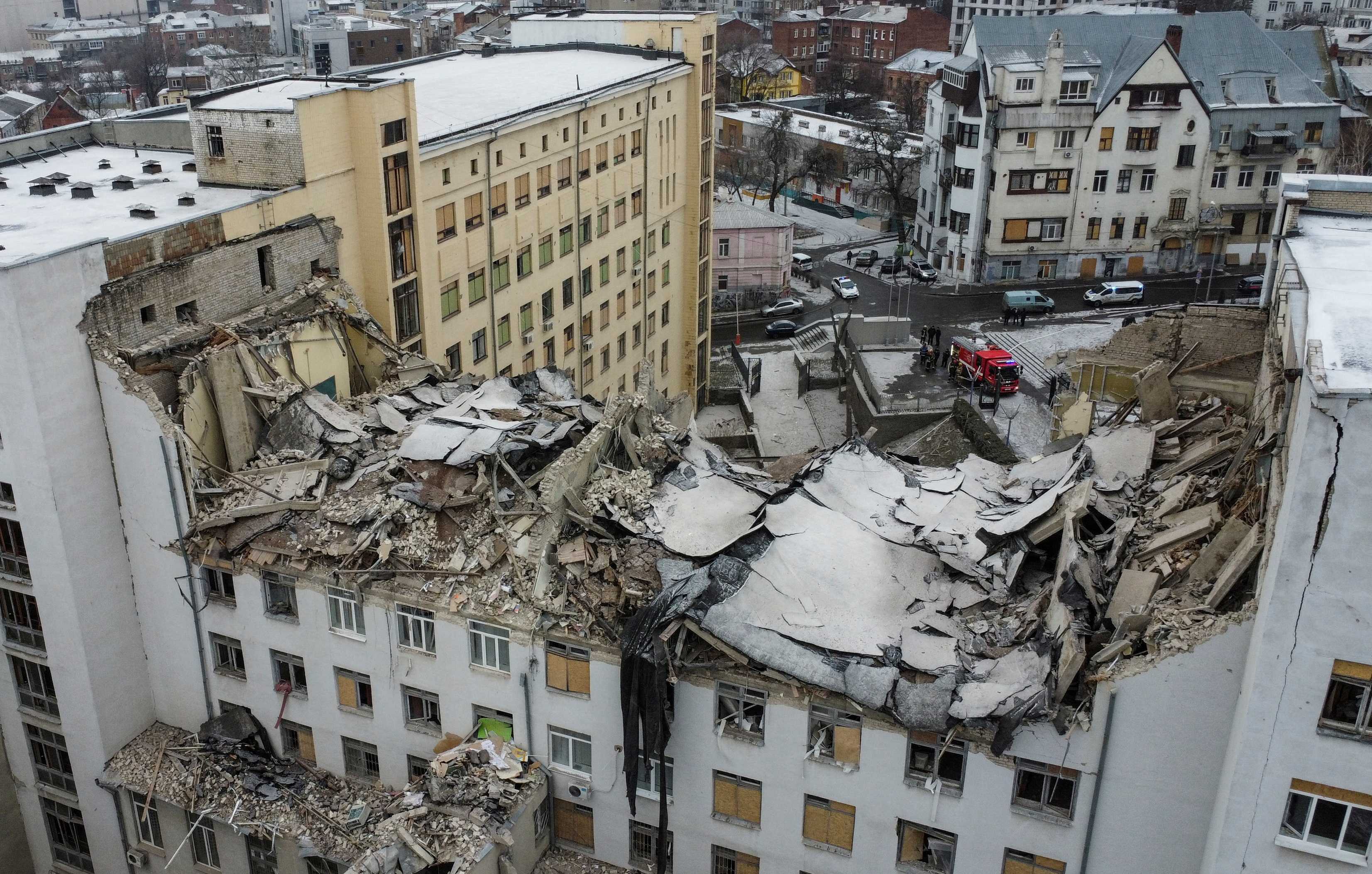 A bird's eye view shows a building of the National University of Urban Economy heavily damaged by a Russian missile, amid Russia's attack on Ukraine, in central Kharkiv, Ukraine. The multistoried building's top floors are crumpled in a mass of debris.