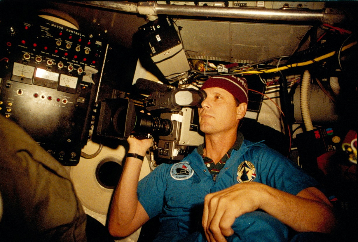 Robert Ballard looking through a device at the wreckage