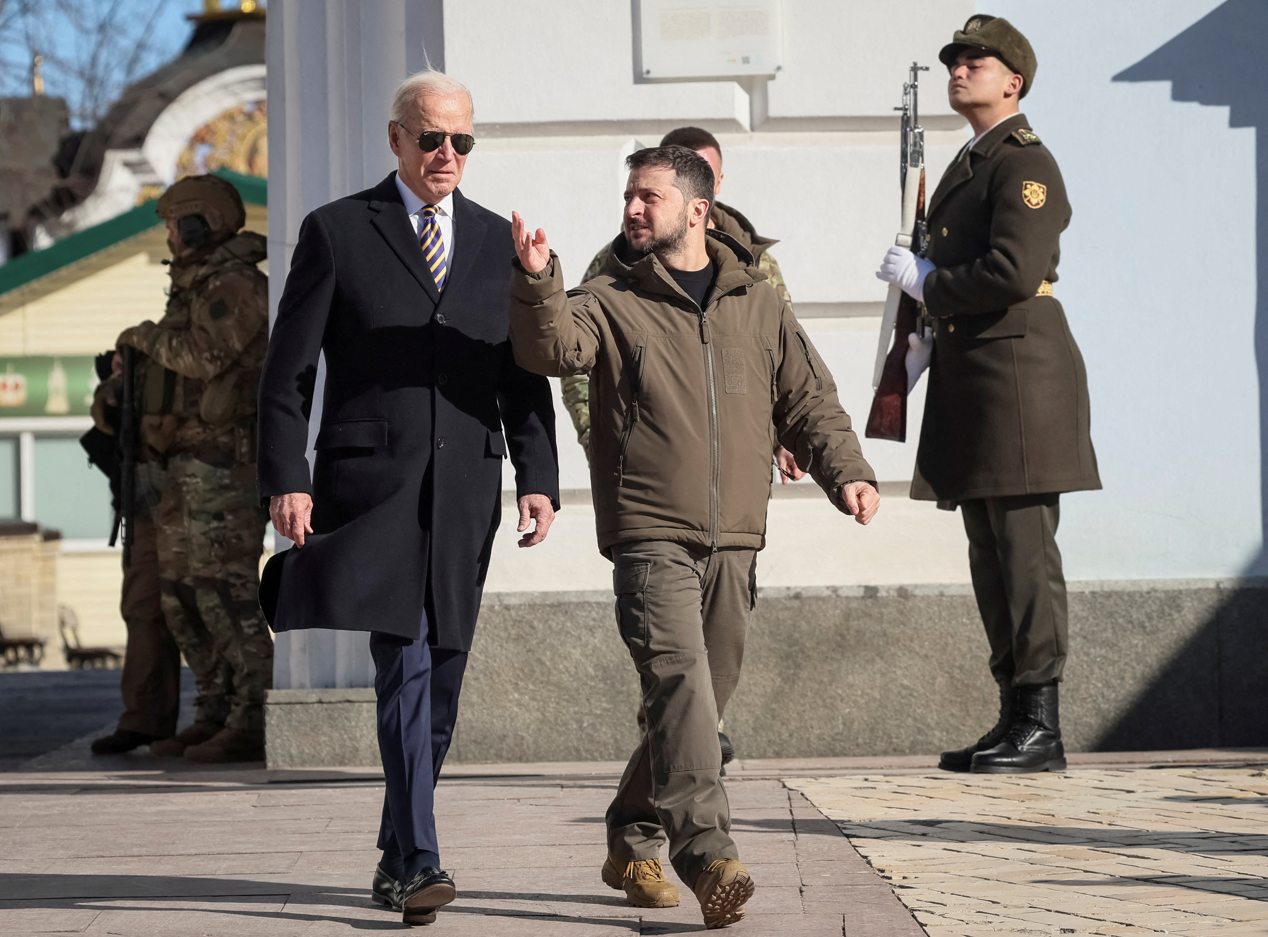 U.S. President Joe Biden and Ukraine's President Volodymyr Zelenskiy walk next to Saint Michael’s cathedral, amid Russia's attack on Ukraine, in Kyiv, Ukraine February 20, 2023. REUTERS/Gleb Garanich TPX IMAGES OF THE DAY