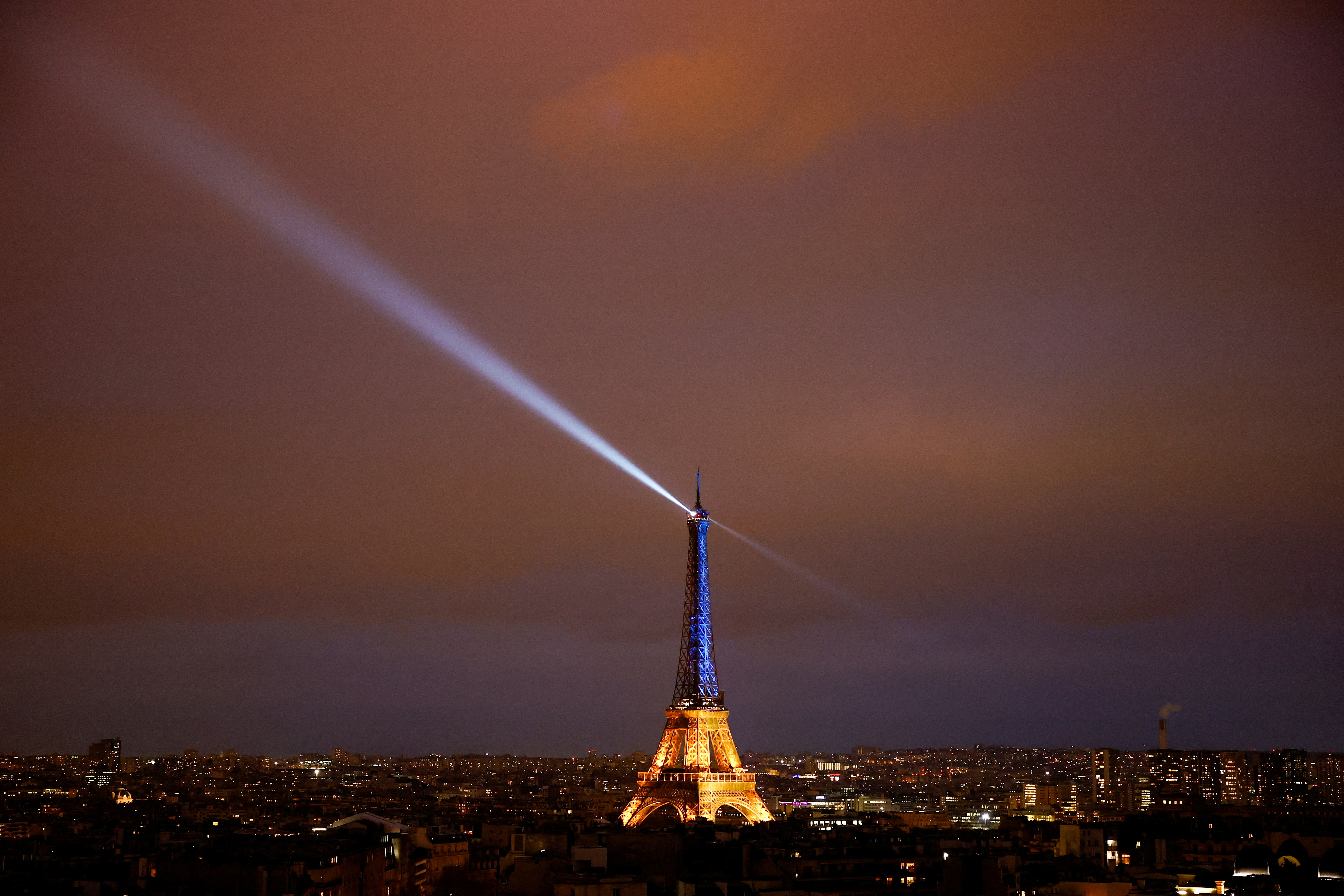 The Eiffel Tower is lit up in the national blue-and-yellow colours of Ukraine, to mark the first anniversary of Russia's invasion of Ukraine, in Paris, France.