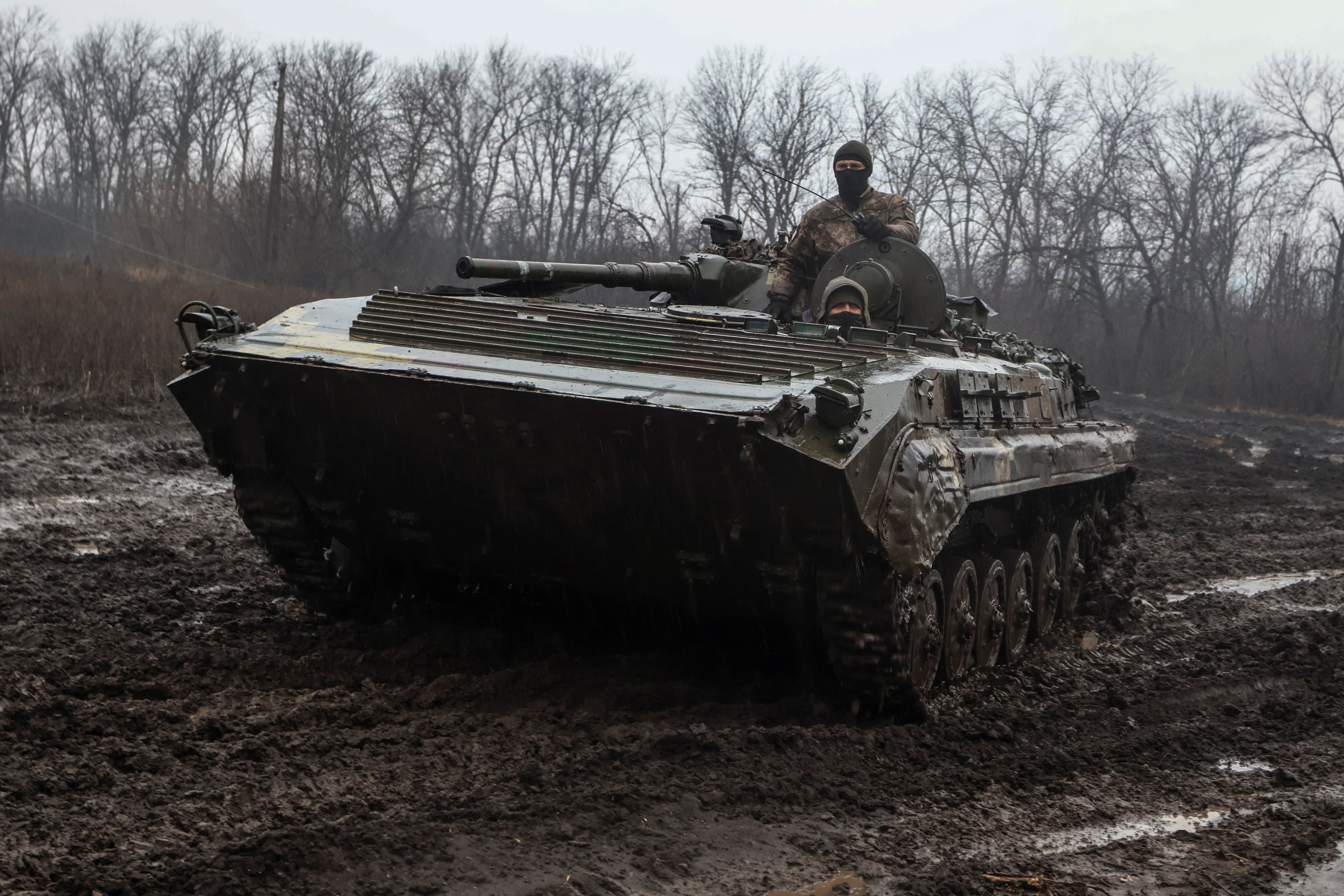 Ukrainian service members ride inside an infantry fighting vehicle near the frontline town of Bakhmut, amid Russia's attack on Ukraine, in Donetsk region, Ukraine February 25, 2023. REUTERS/Yan Dobronosov