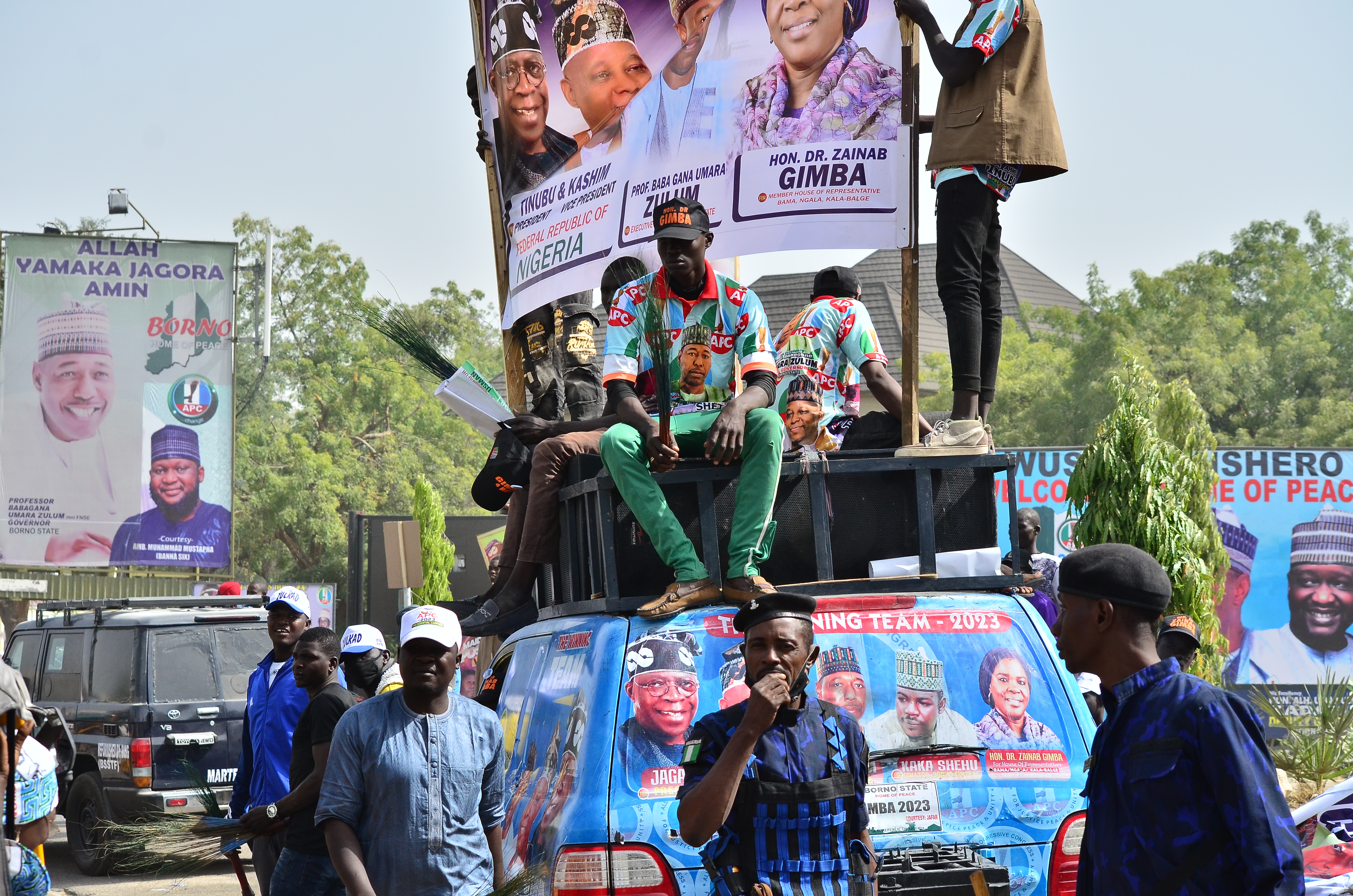 Supporters sit on a vehicle during an All progressives Congress (APC) rally in Maiduguri on February