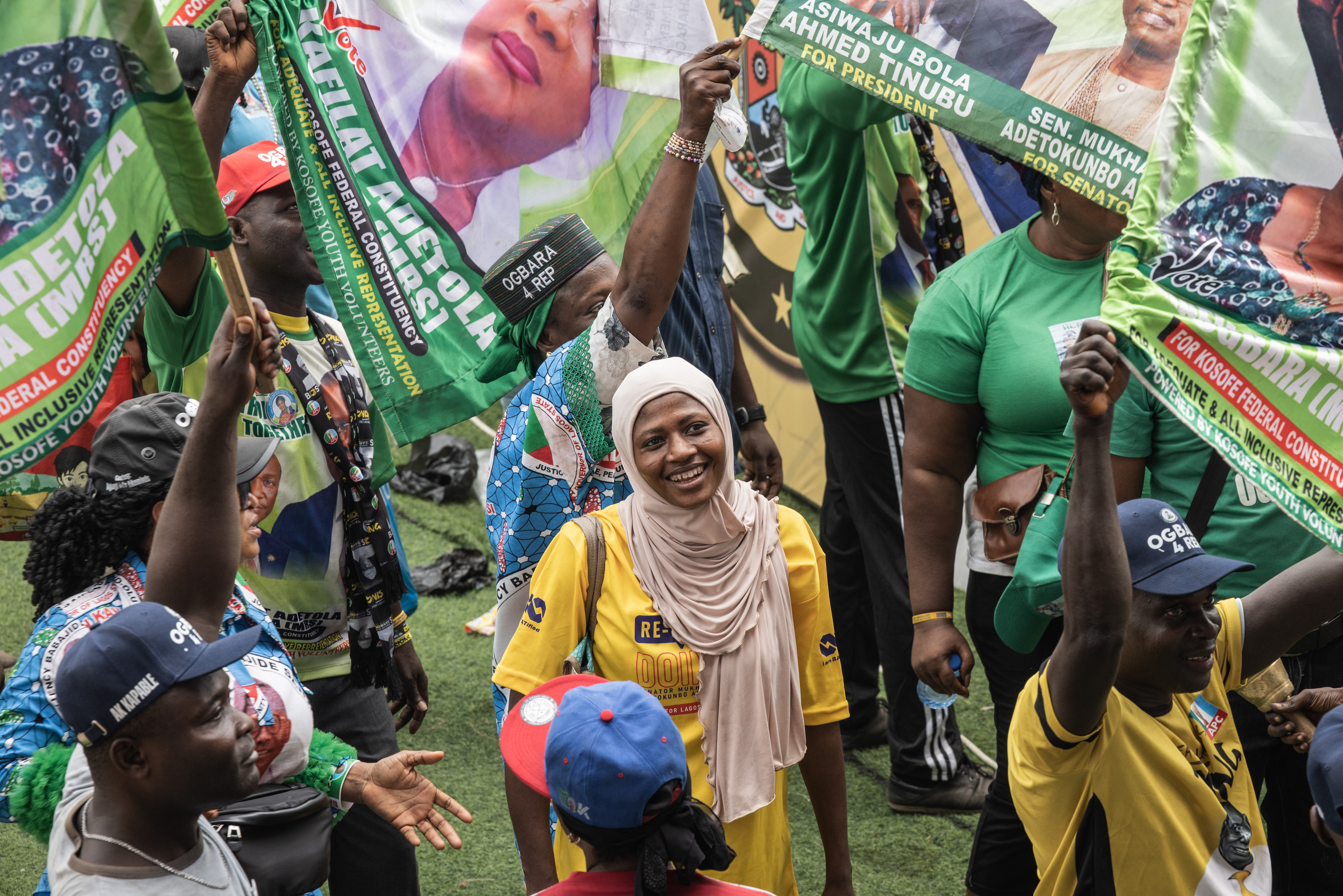 A supporter of the All Progressives Congress (APC) smiles at the Teslim Balogun Stadium during their final campaign rally in Lagos on February 21, 2023, ahead of the Nigerian presidential election scheduled for February 25, 2023. (Photo by JOHN WESSELS / AFP)