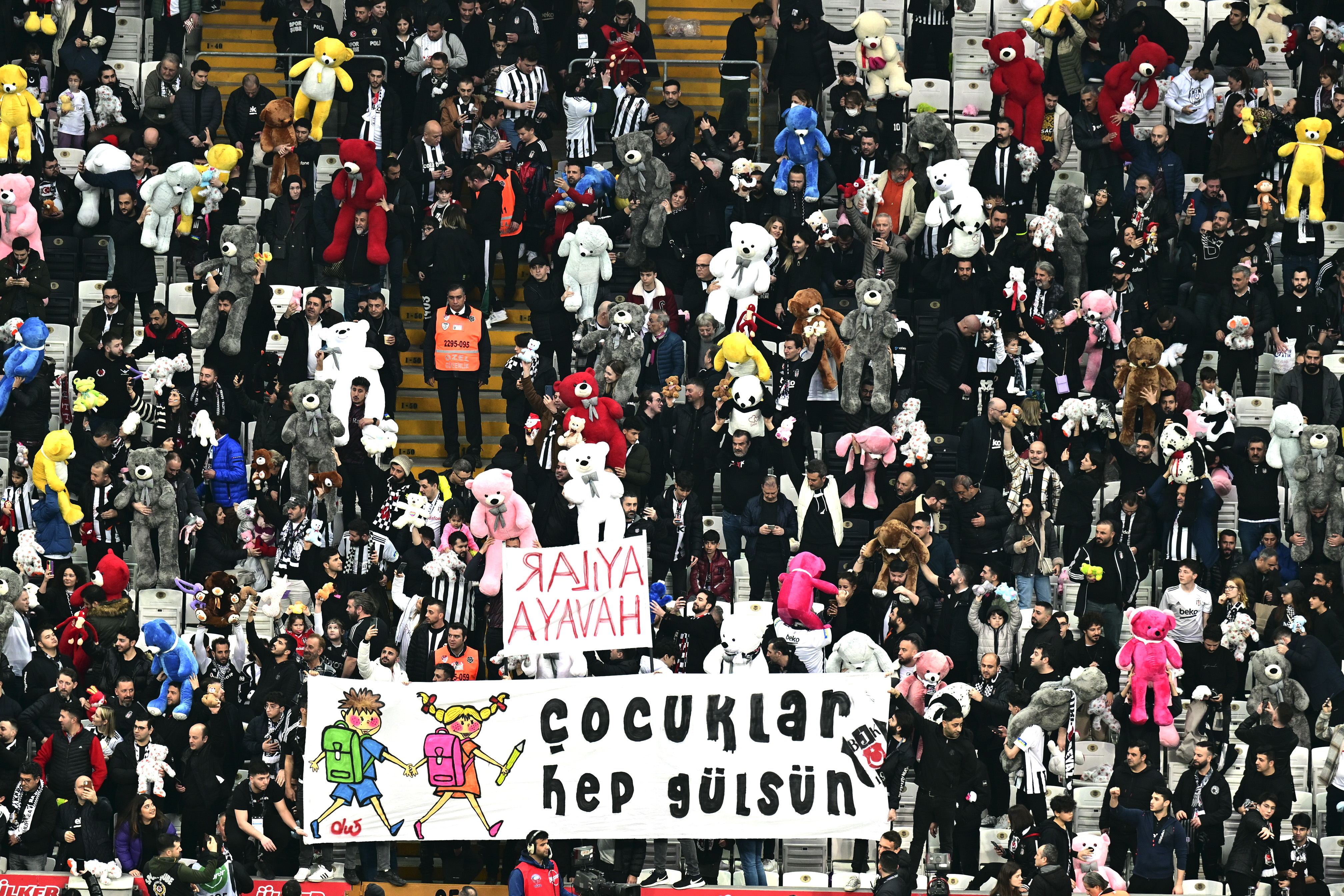 Fans throw toys onto the pitch during the Turkish Super League football match