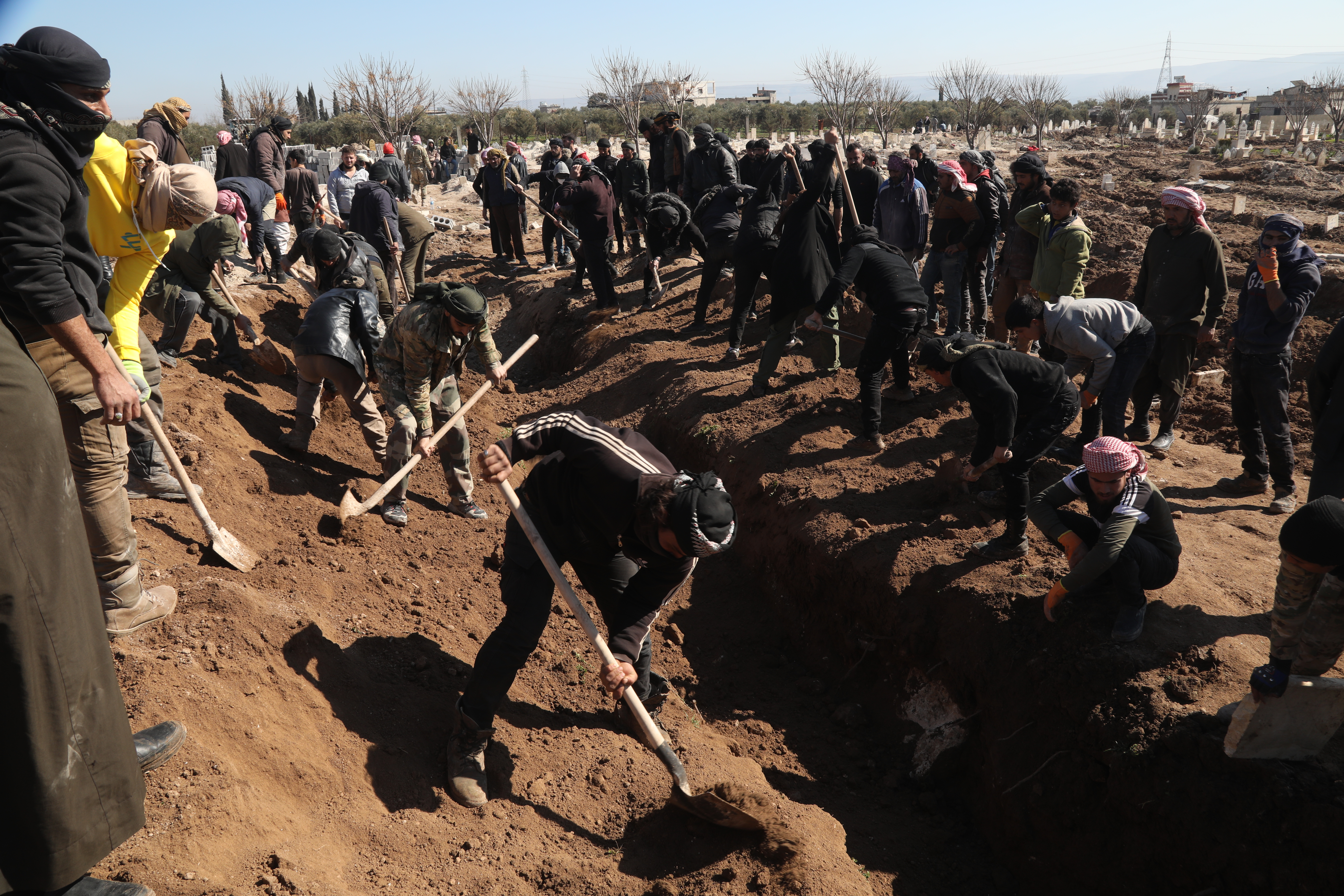 gravediggers filling in the trench