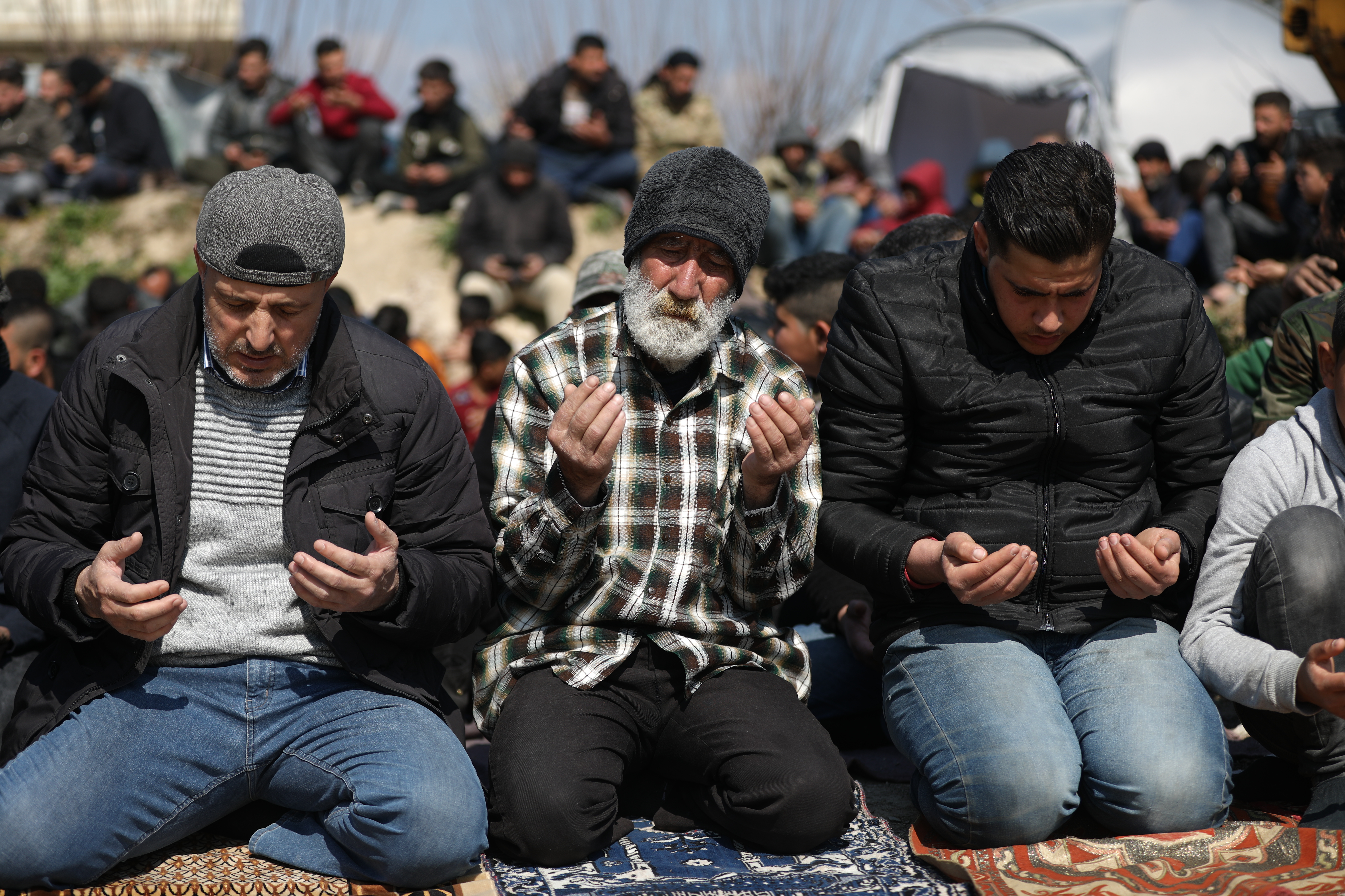 Worshippers raise their hands in supplication and prayer