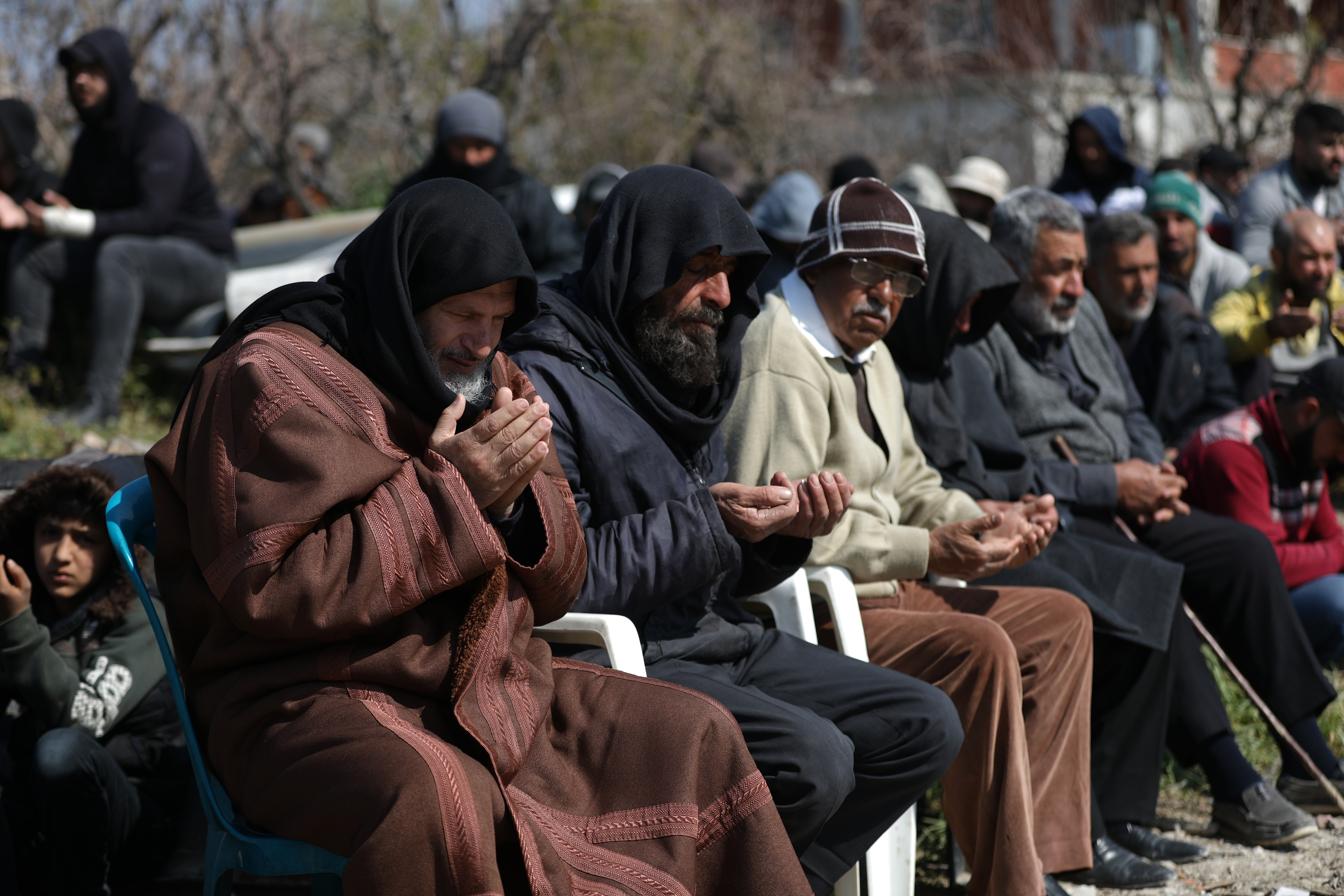 Those who cannot stand and kneel had for prayers to sit on scavenged chairs