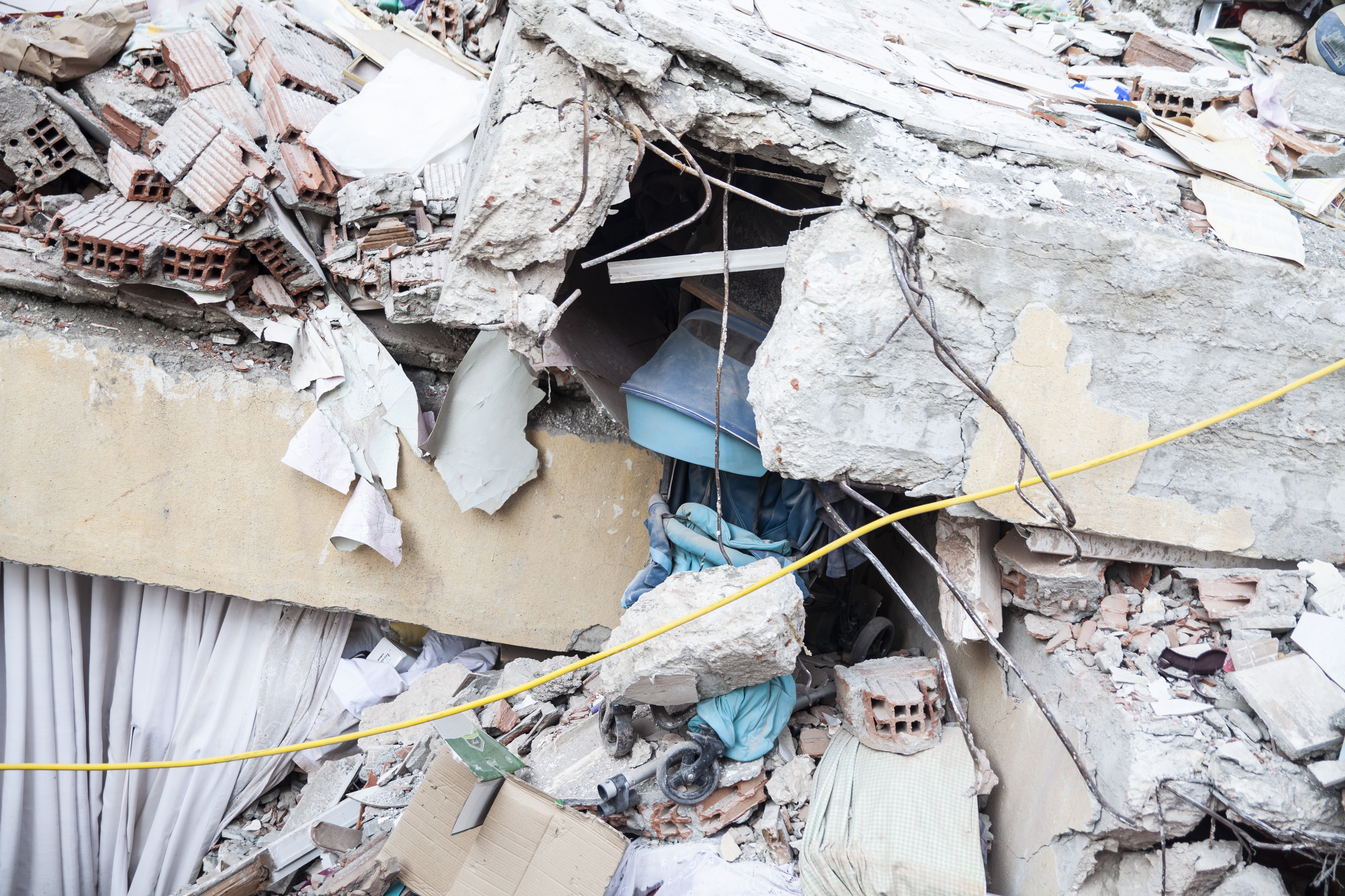 A pram caught in the destruction of one of the buildings is a haunting sign of how young the victims are of the earthquake