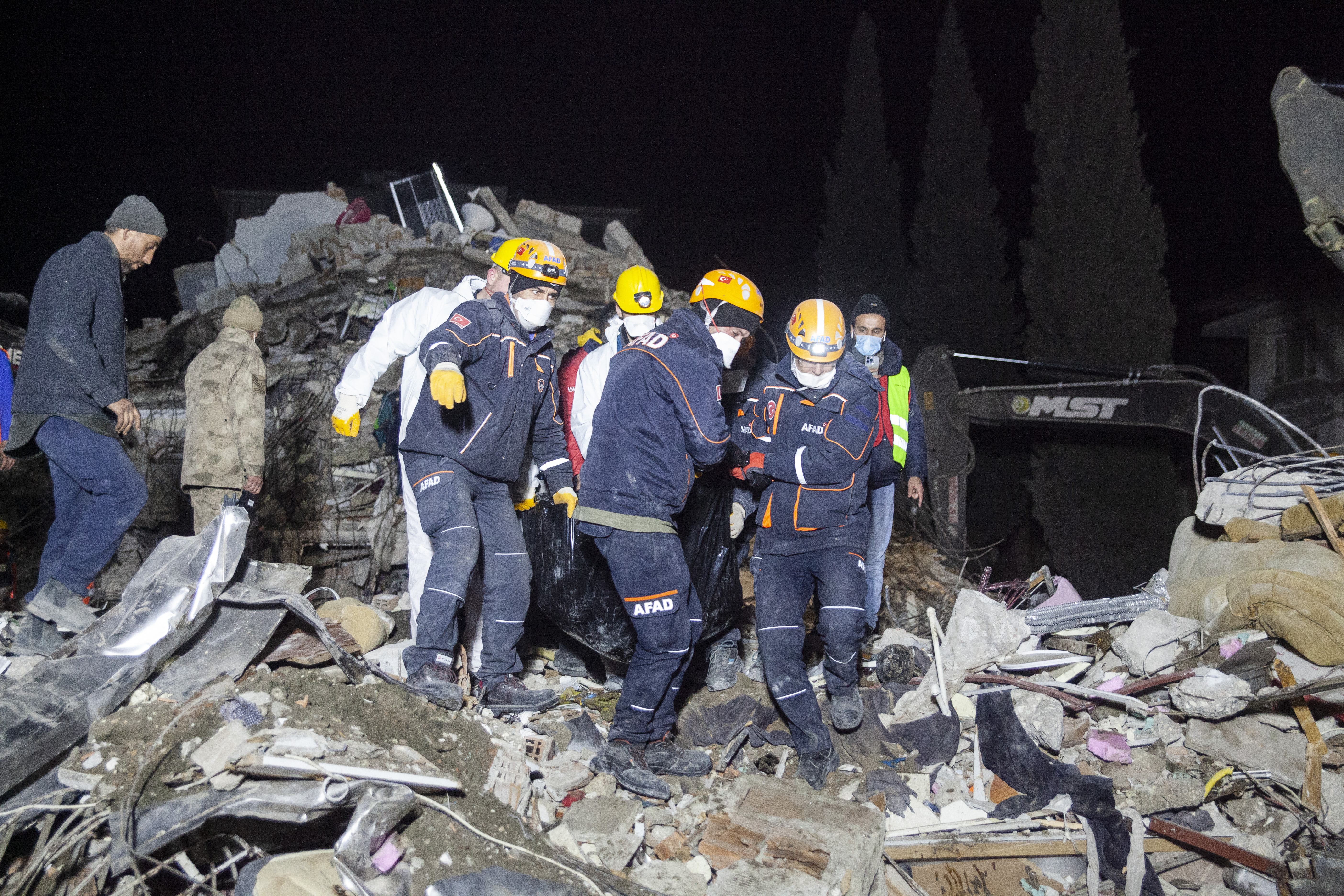 her body is brought out, as security personnel push the distraught mother away