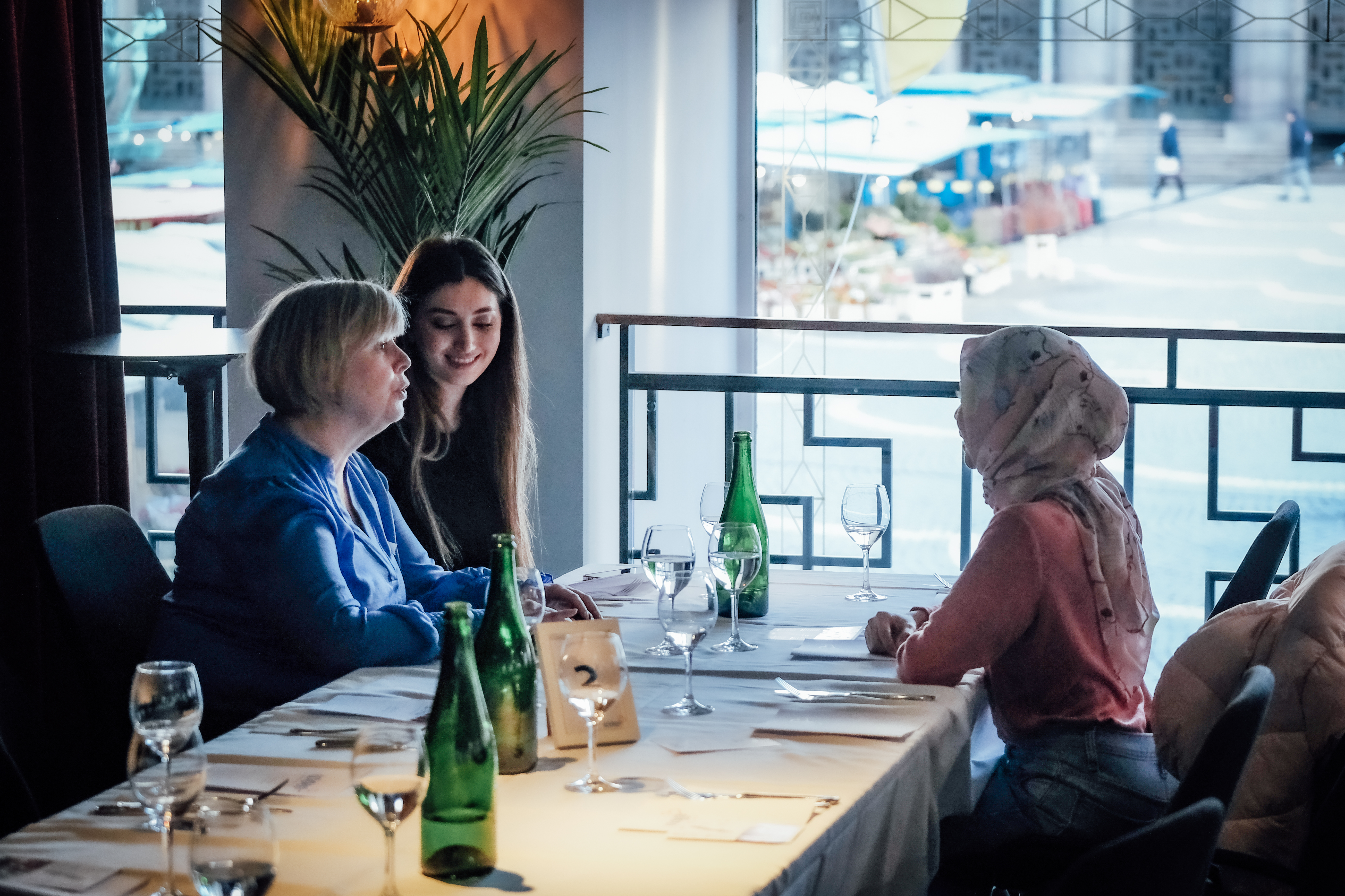 Three women sit at a table having lunch in Sweden