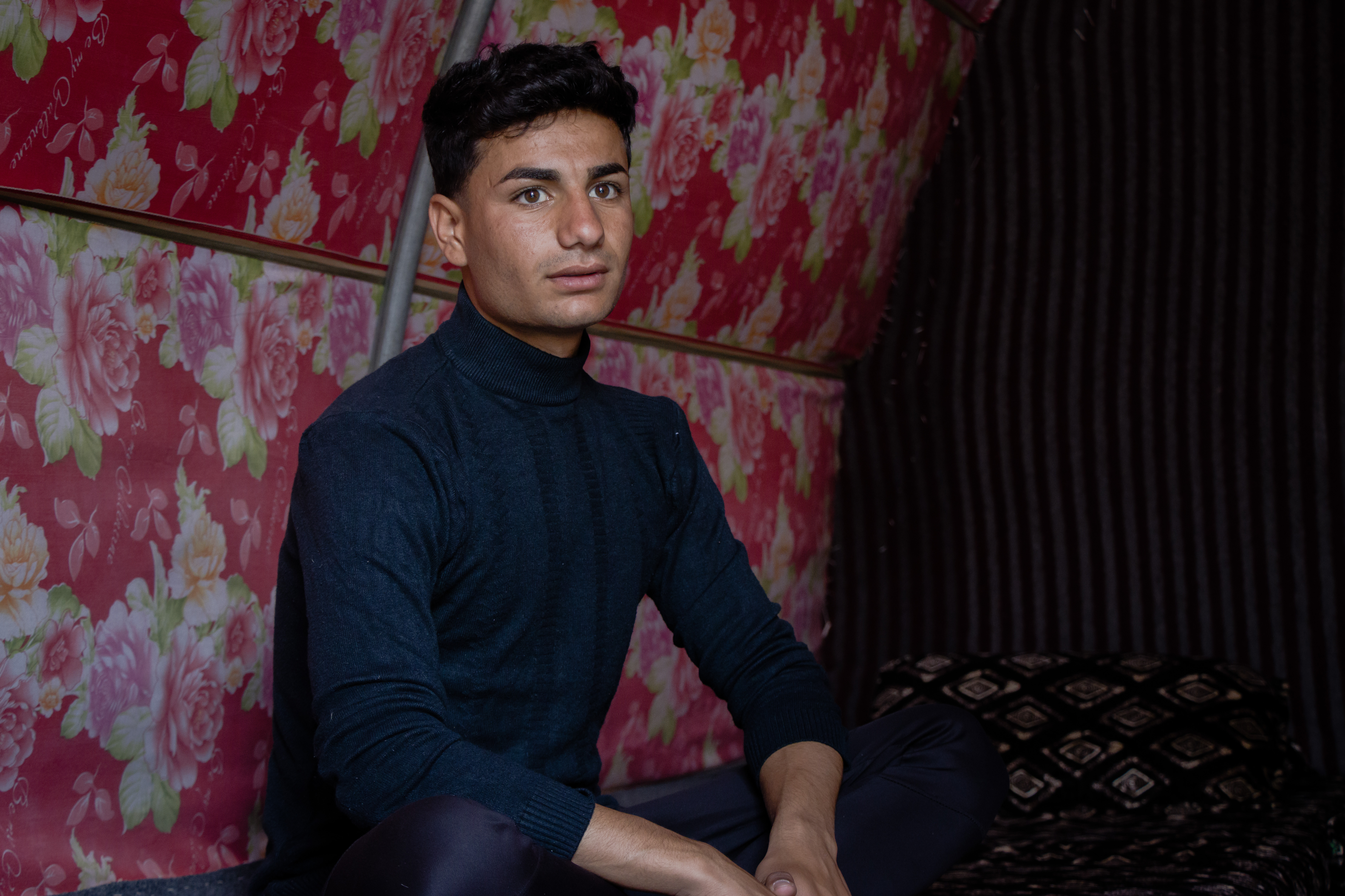 A photo of Nazar sitting in his tent.