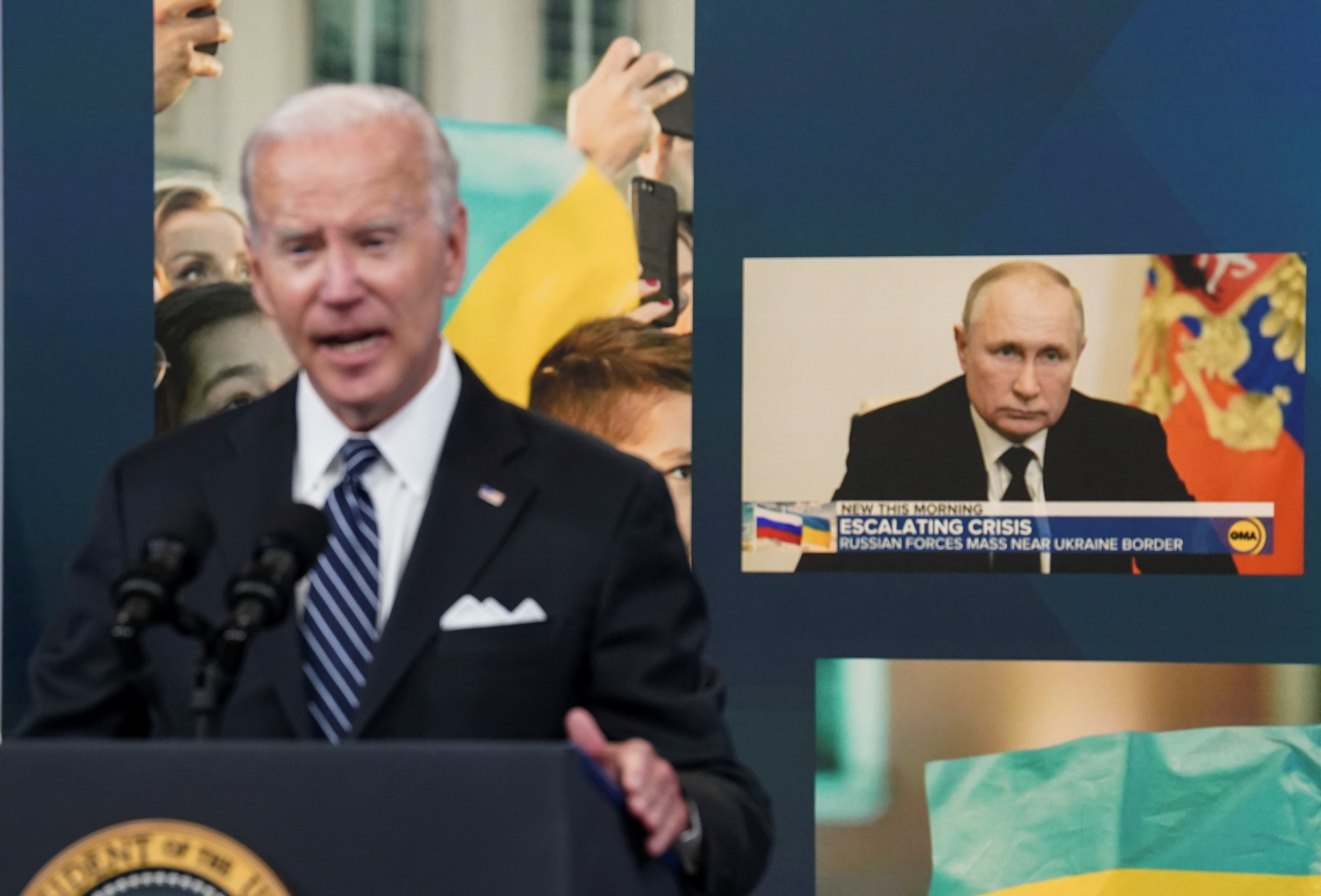 Russia's President Vladimir Putin is seen on a display in the background as U.S. President Joe Biden speaks about "gas prices and Putin's Price Hike" during remarks in the Eisenhower Executive Office Building's South Court Auditorium at the White House in Washington, U.S., June 22, 2022. REUTERS/Kevin Lamarque