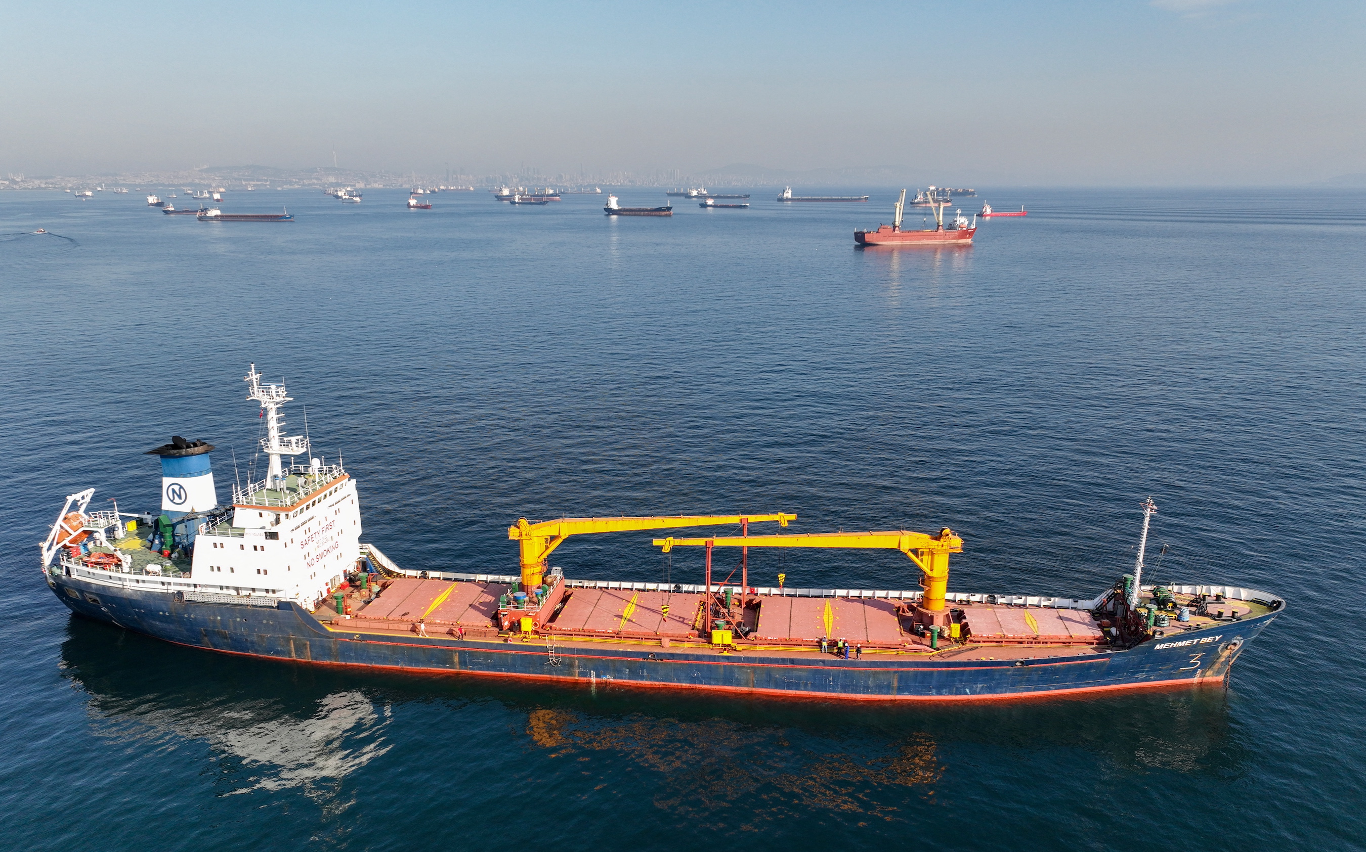 The Joint Coordination Centre officials board cargo ship Mehmet Bey as she waits to pass the Bosphorus strait off the shores of Yenikapi during a misty morning in Istanbul, Turkey, October 31, 2022.
