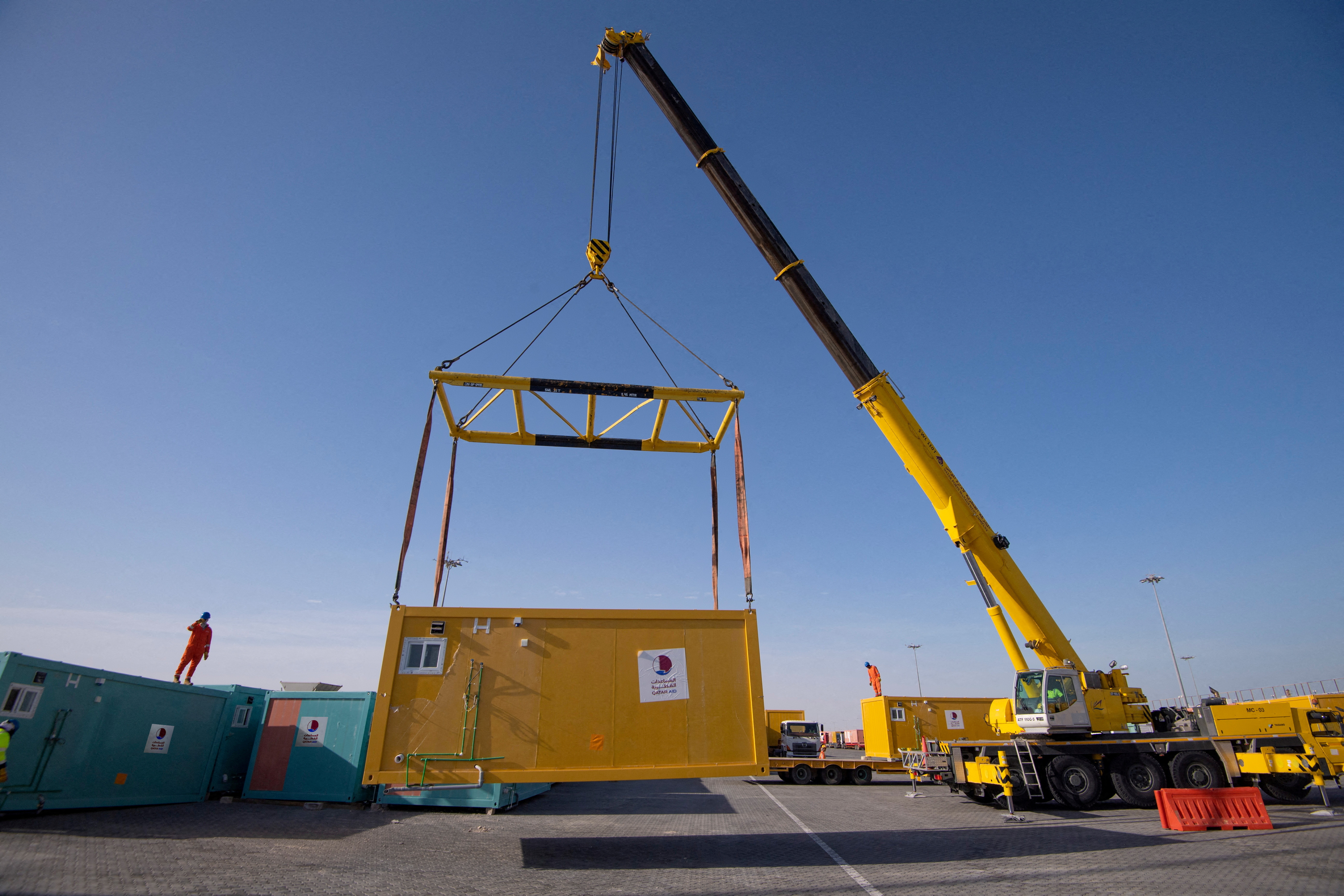 One of a batch of mobile home cabins that Qatar has allocated to be transferred to Turkey as part of relief efforts in the aftermath of a deadly earthquake is transported in Hamad Port, Qatar, February 12, 2023. The 10,000 porta-cabins Qatar has pledged to send to Turkey and Syria were originally used to accommodate soccer fans who visited Qatar during FIFA World Cup Qatar 2022