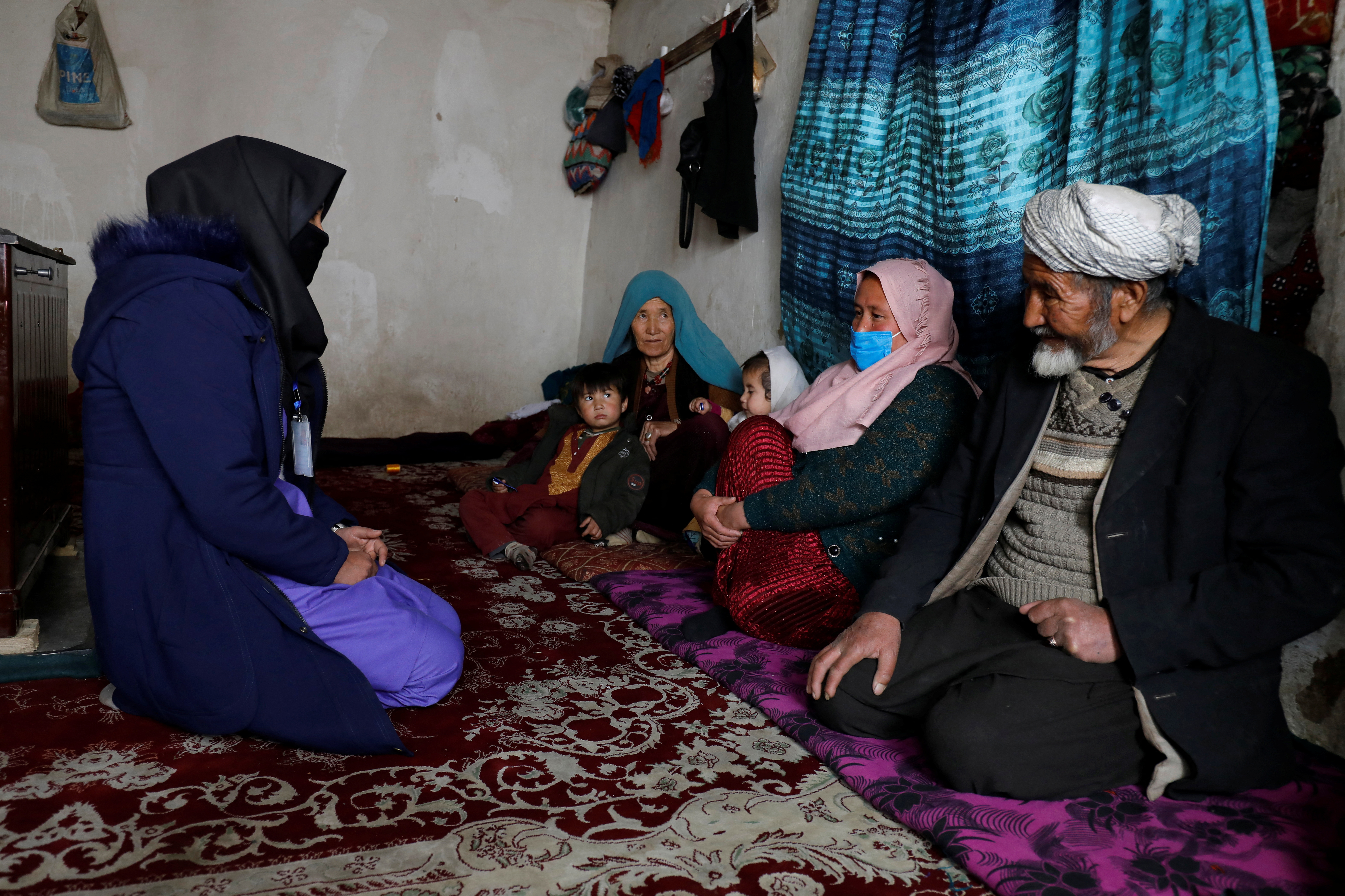 Aziza Rahimi, 35, who lost her son at birth, talks to a trainee midwife in Foladi Valley in Bamiyan, Afghanistan