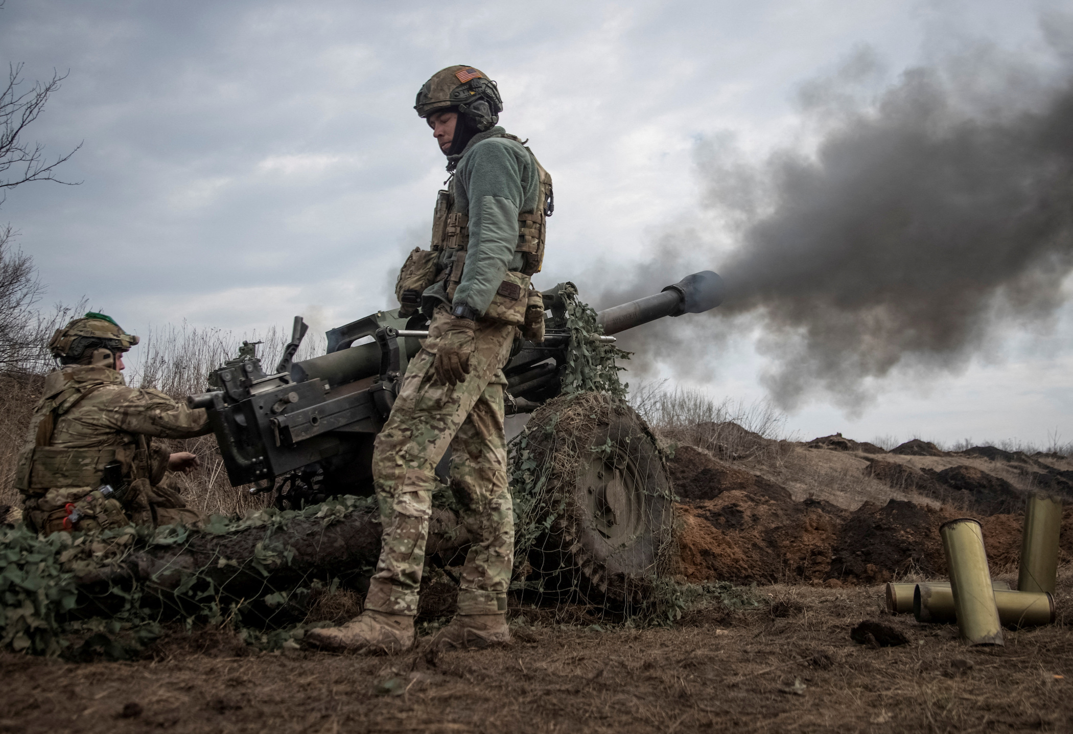 FILE PHOTO: Ukrainian service members fire a howitzer M119 at a front line, amid Russia's attack on Ukraine, near the city of Bakhmut, Ukraine.