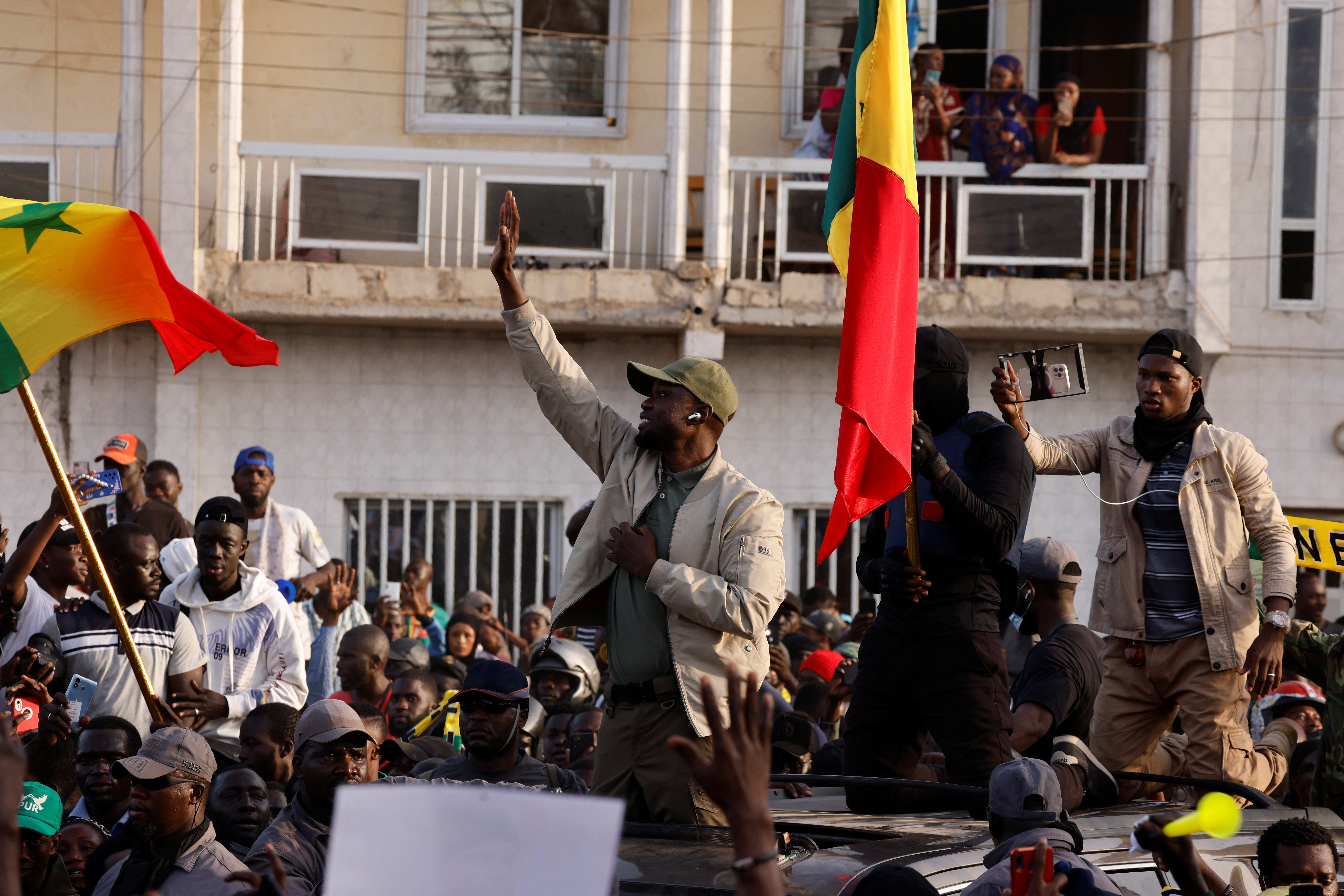 Senegalese opposition leader Ousmane Sonko greets his supporters as he arrives to attend the protest to demand the release of alleged political prisoners ahead of his court appearance on Thursday on libel charges.