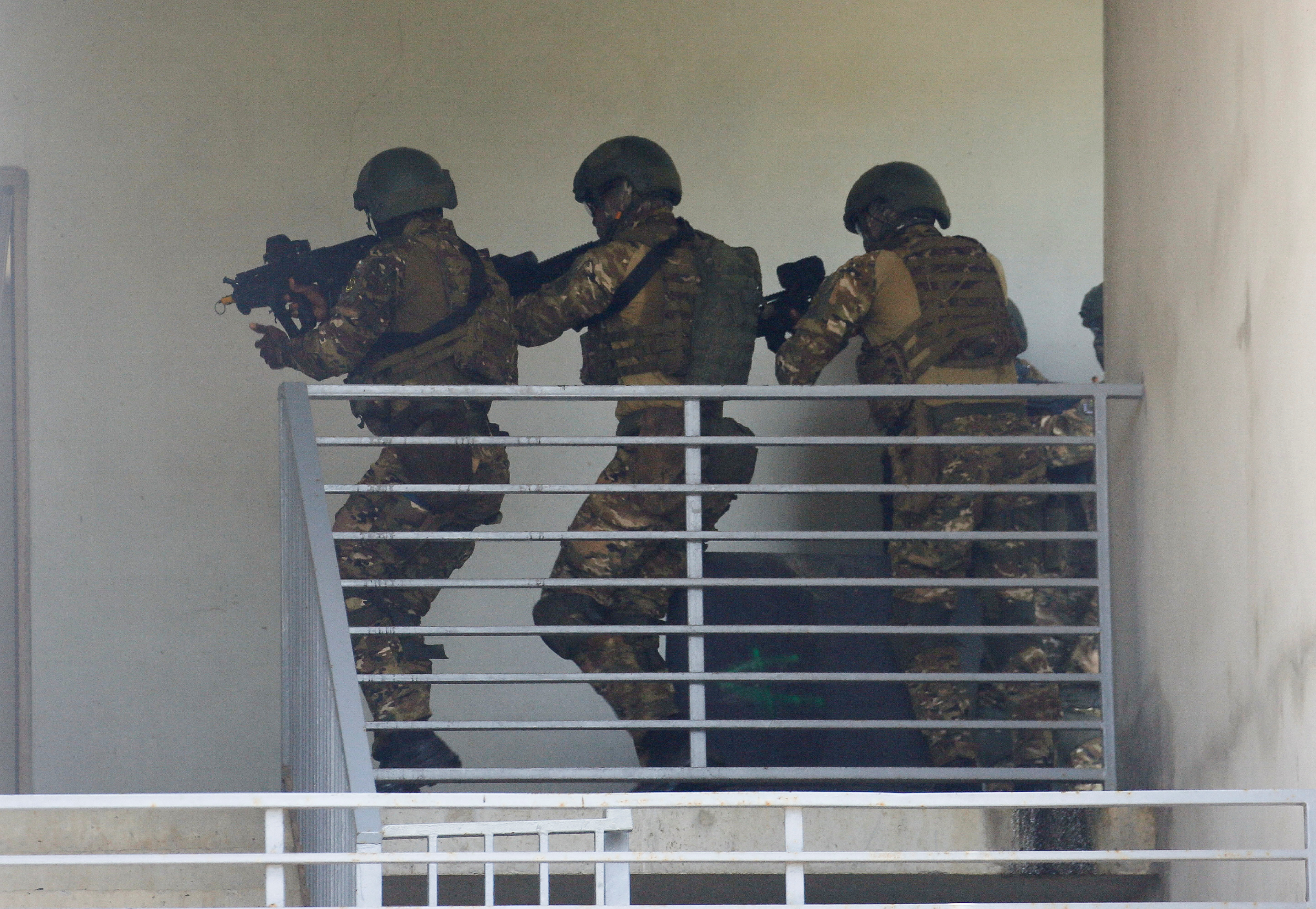 West African Soldiers from Ivory Coast, Burkina Faso and Niger participate in a simulated raid during the U.S. sponsored Flintlock exercises at the site of the new French-backed international counter-terrorism academy in Jacqueville, Ivory Coast March 14, 2023. REUTERS/Luc Gnago