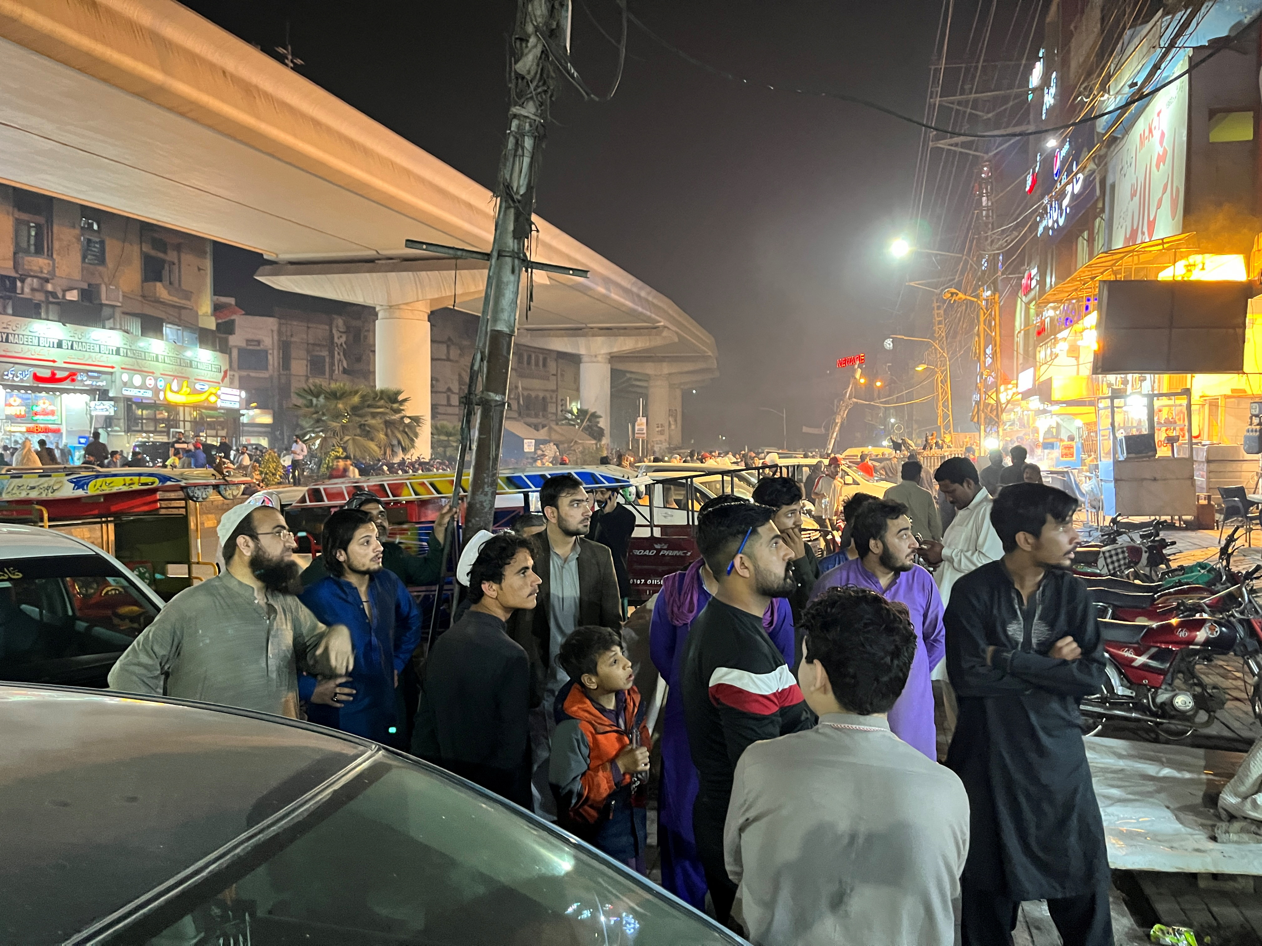 People come out of a restaurant in Lahore