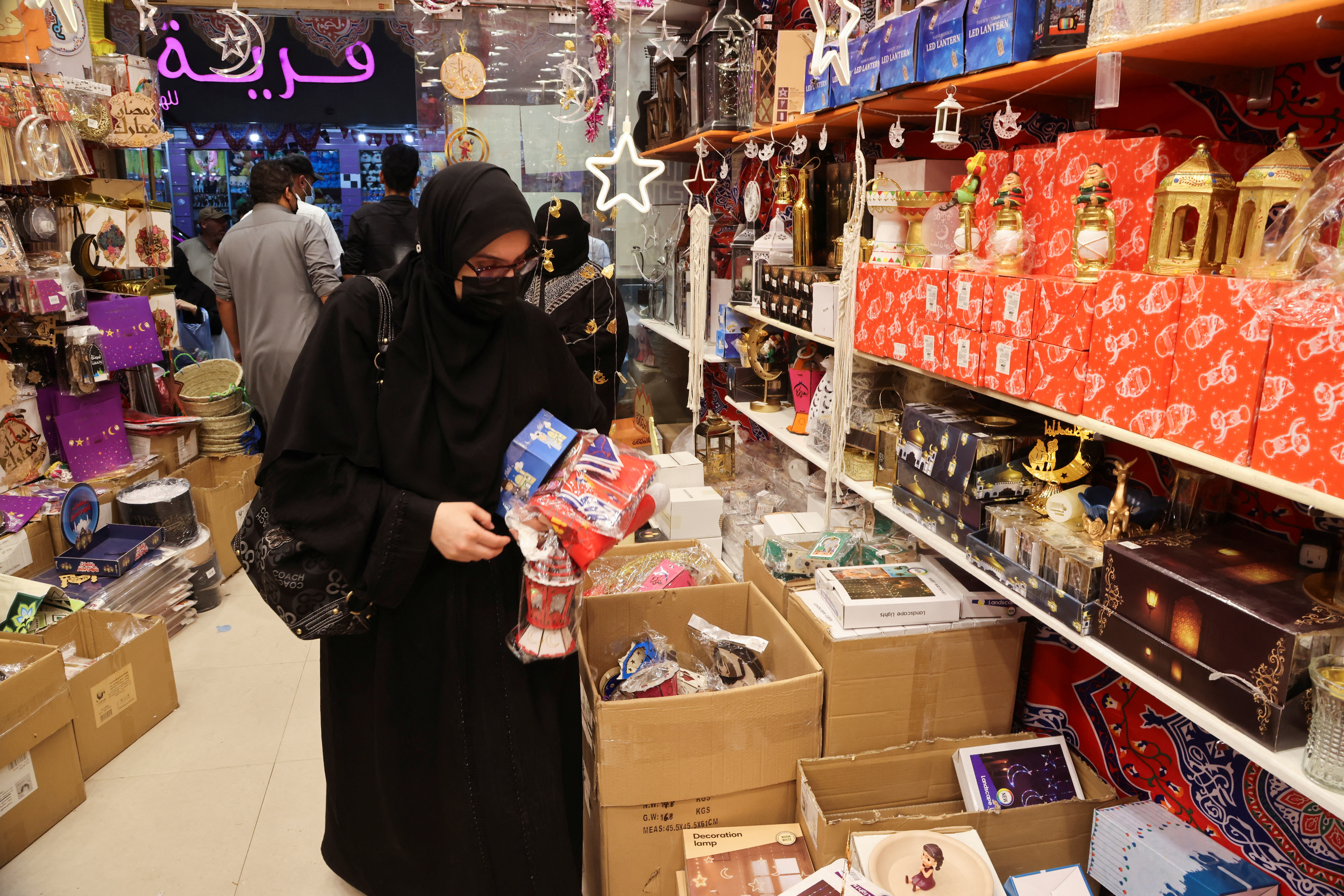 A Saudi woman shops for Ramadan decorations to mark the beginning of the Holy Month of Ramadan in a local market in Riyadh, Saudi Arabia