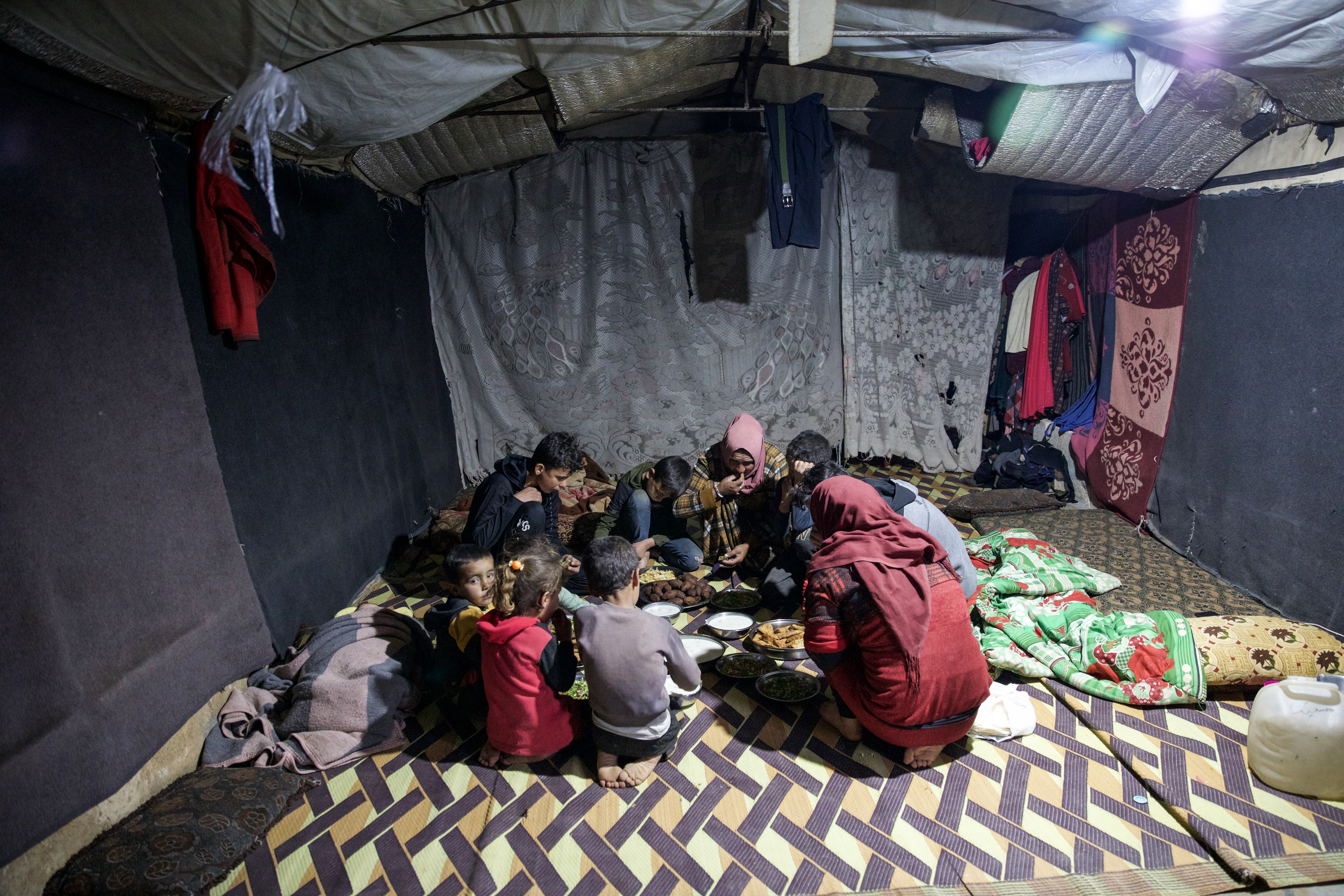 The family eating in their tent