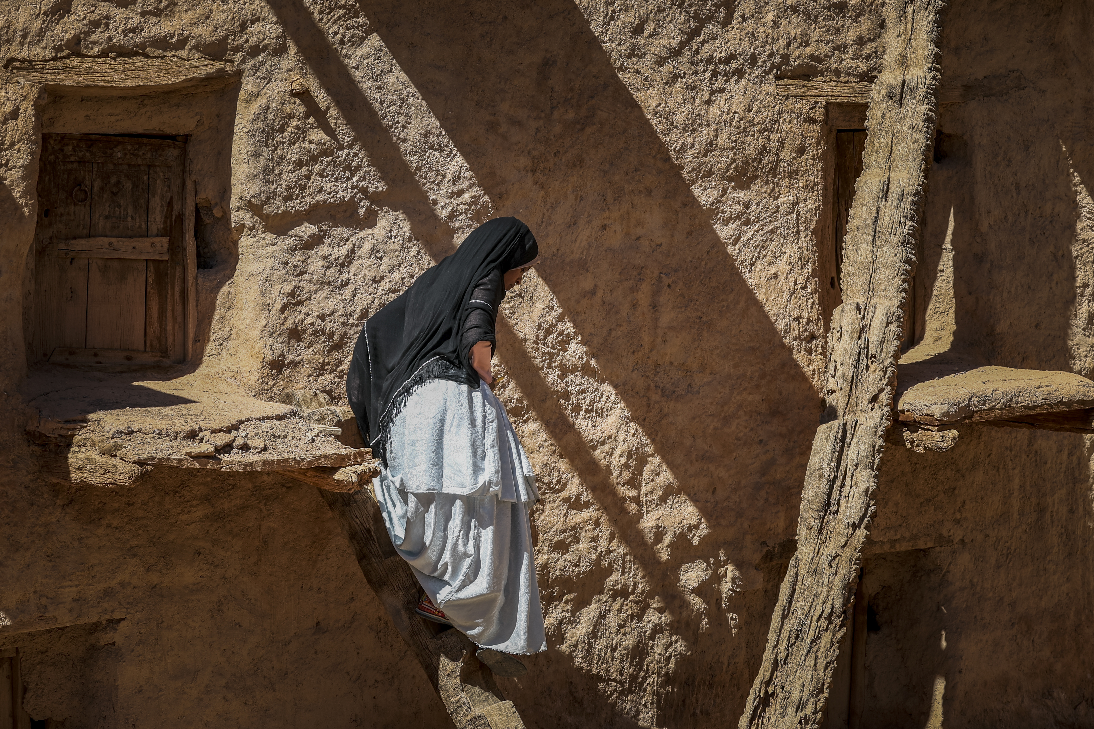 A woman walks at the ancient collective granary of Ait Kine