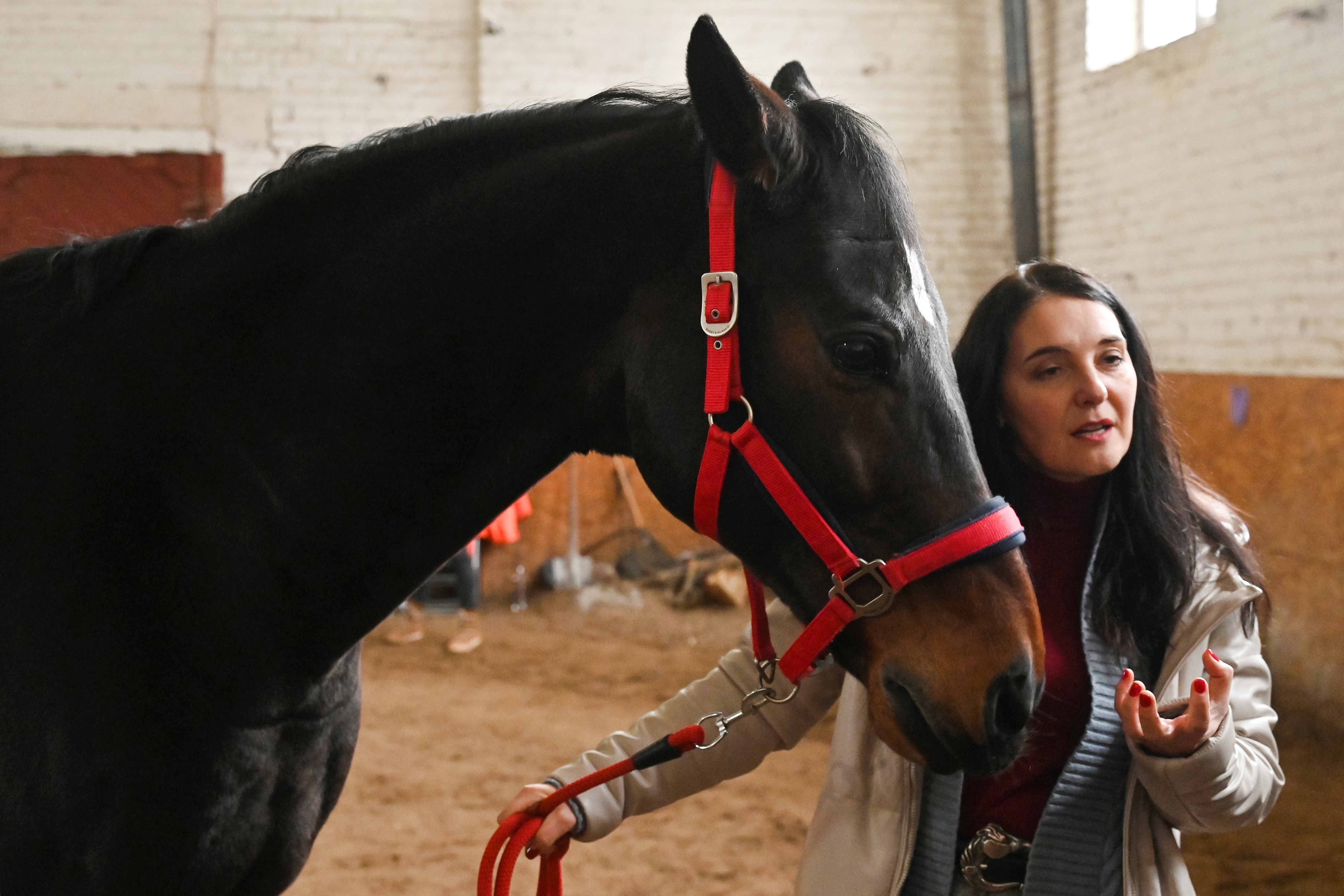 The centre's founder, psychologist Ganna Burago speaks with AFP journalists during a hippotherapy session in Kyiv