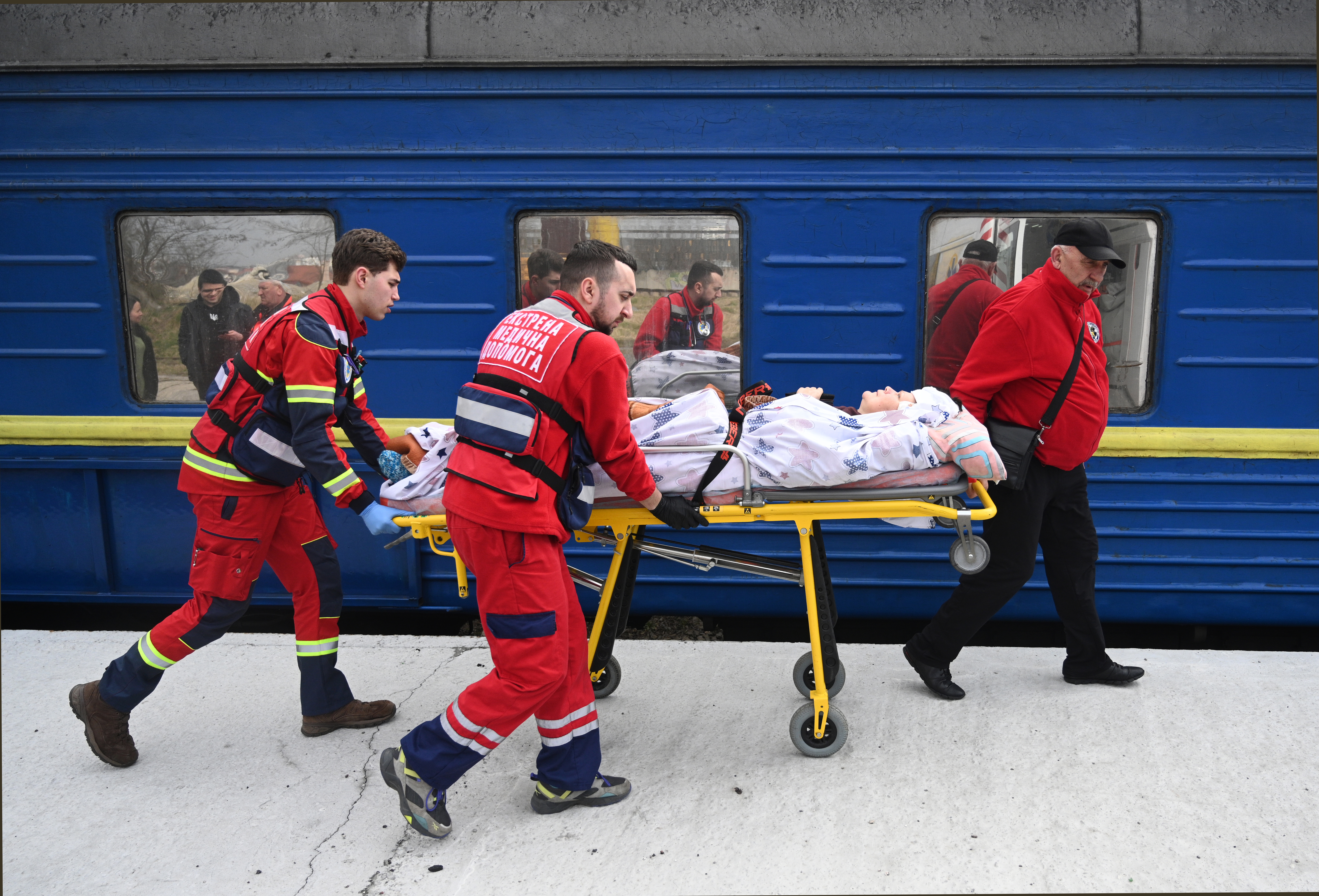 Medical workers transfer a wounded civilian.