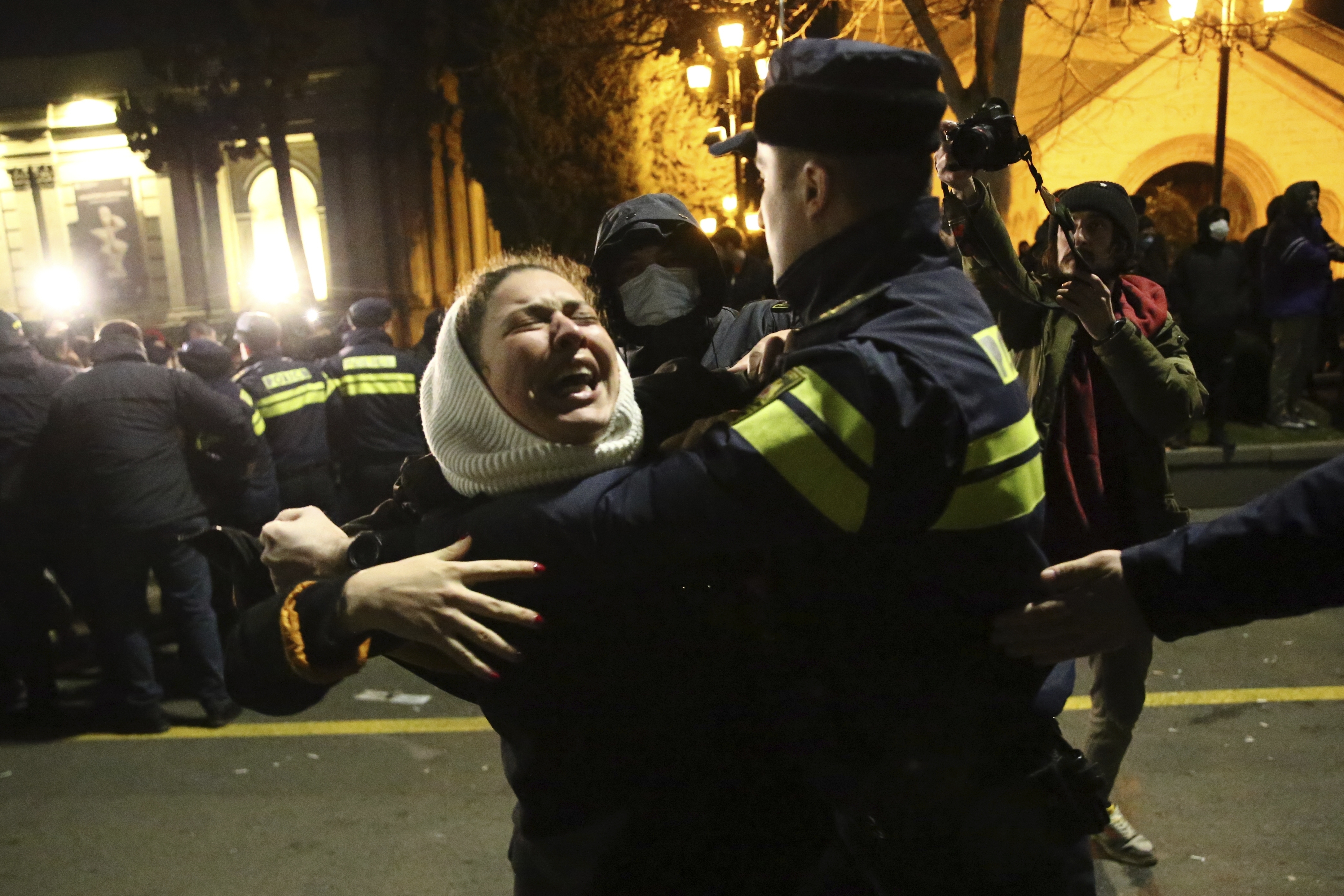 A Georgian police officer detains a protester