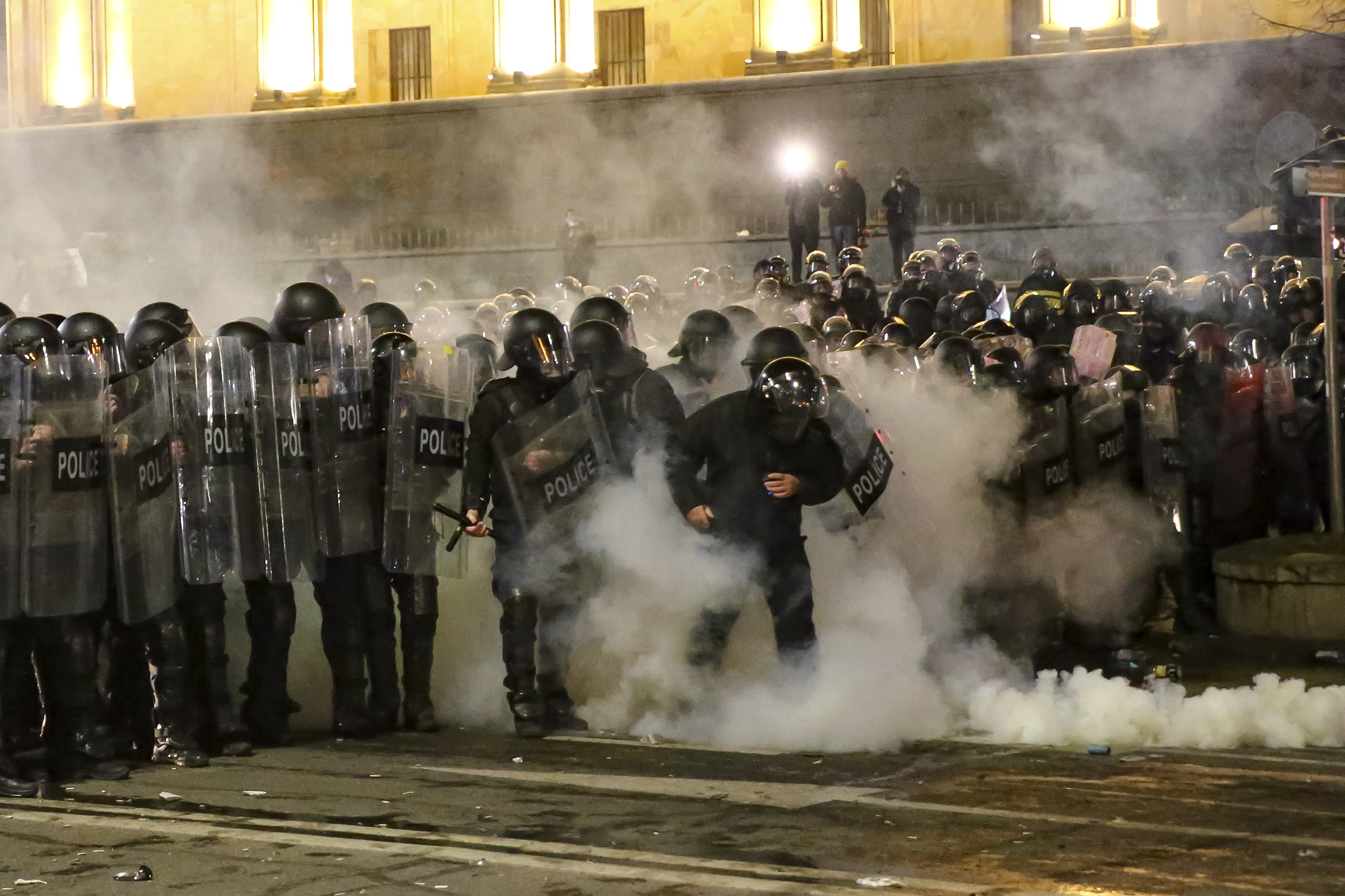 Riot police block a street to stop protesters outside the Georgian parliament building in Tbilisi