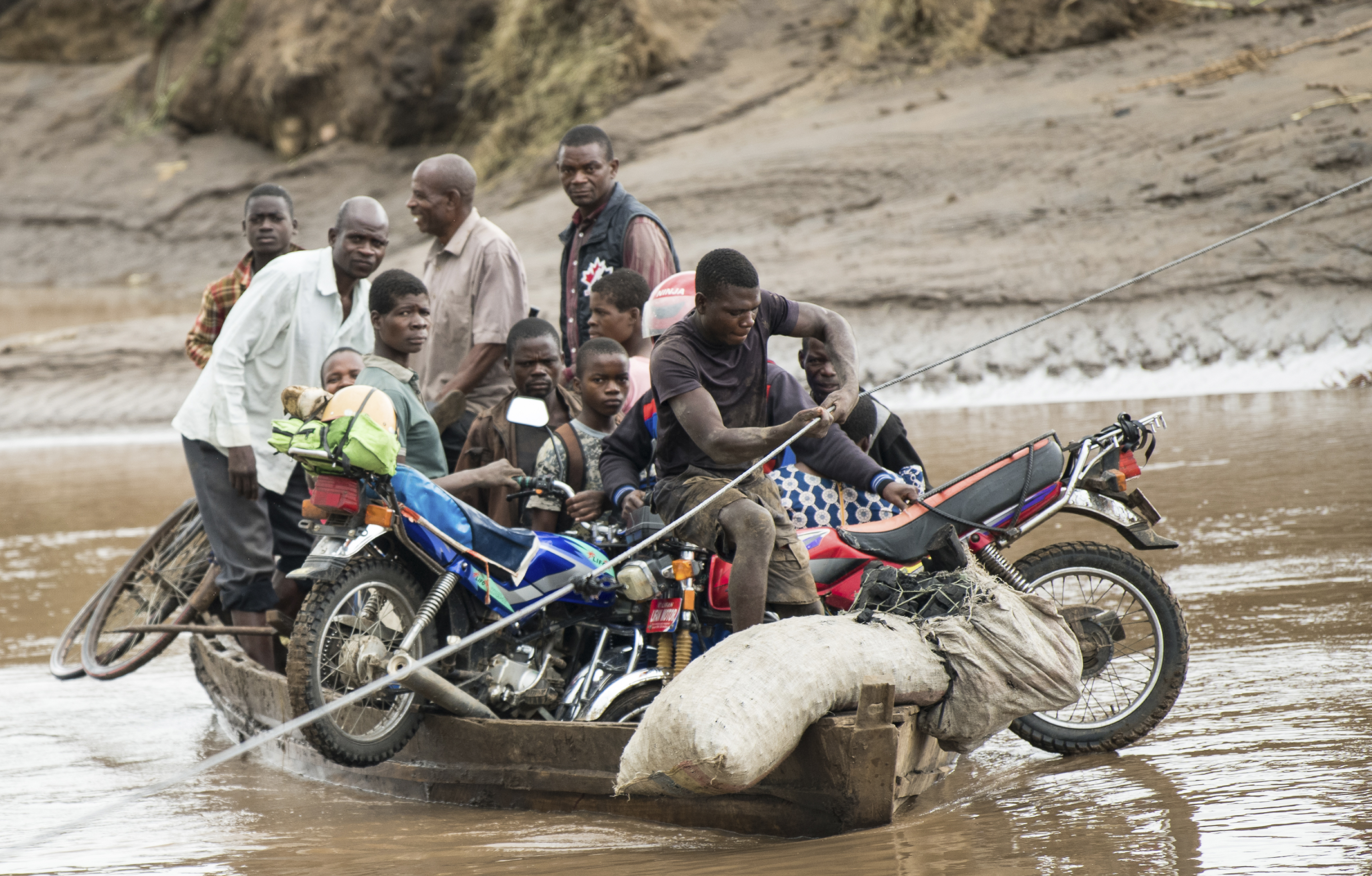 Men transport their salvaged belongings in Chiradzulu, southern Malawi