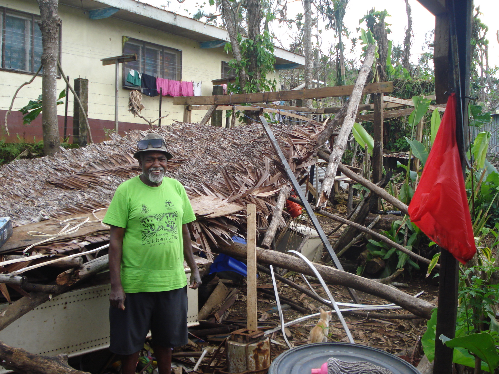 Chief Ken Hivo standing in front of a damaged building in the informal Freswota settlement of Port Vila, Vanuatu. 