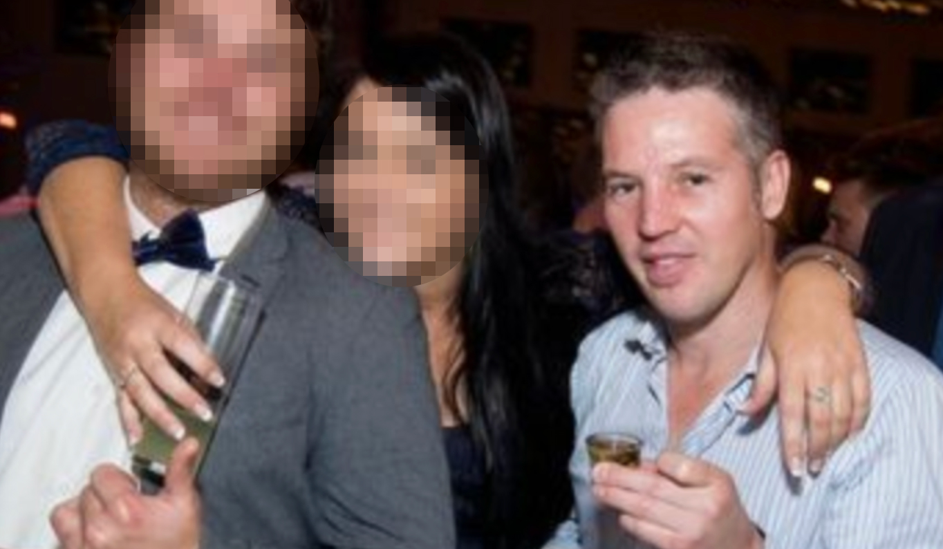 Howie Baker holding a shot glass next to two unidentified people.