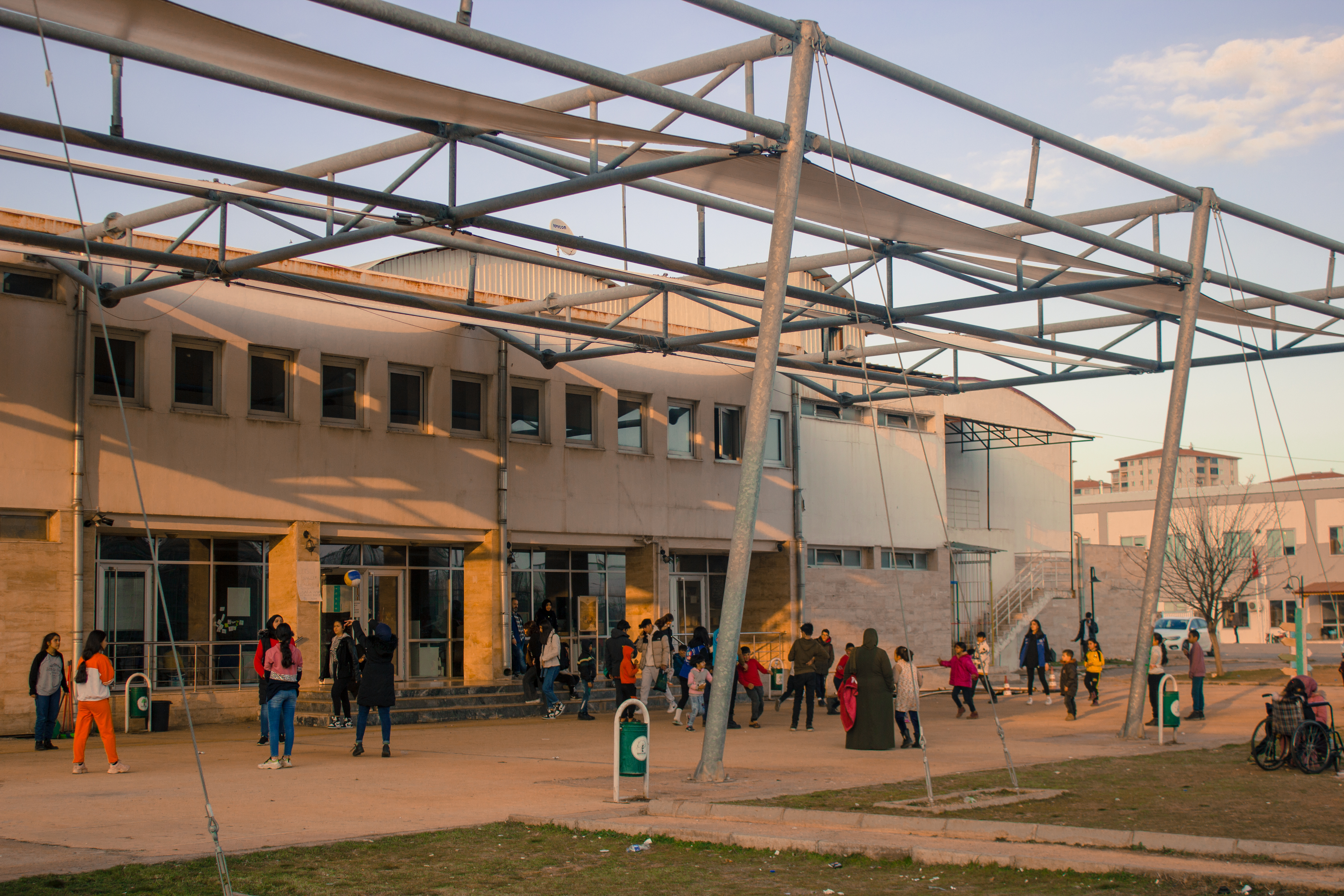 The Gazikent community-centre-turned-shelter with dozens of people milling about outside.