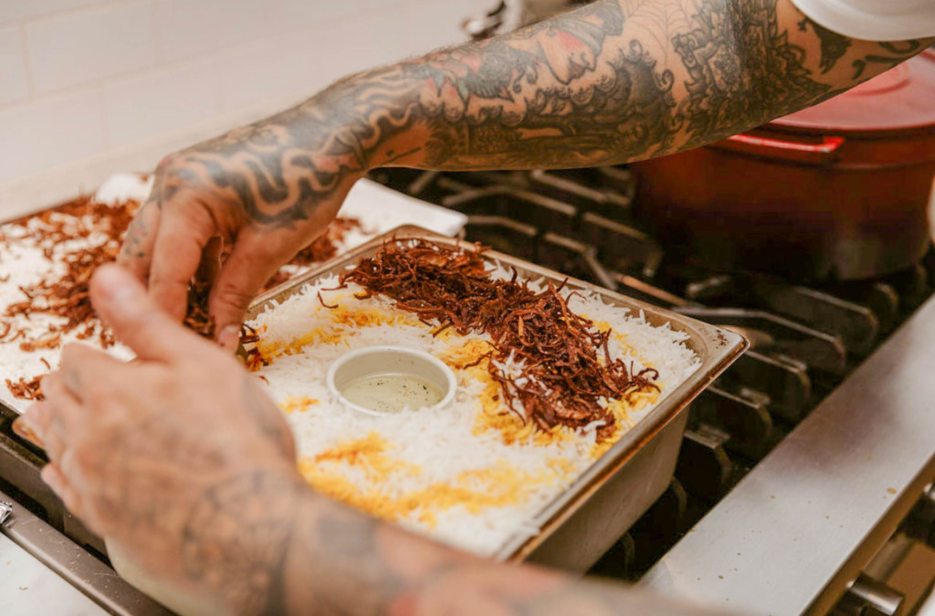 Akram transfering the onions to the rice and chicken