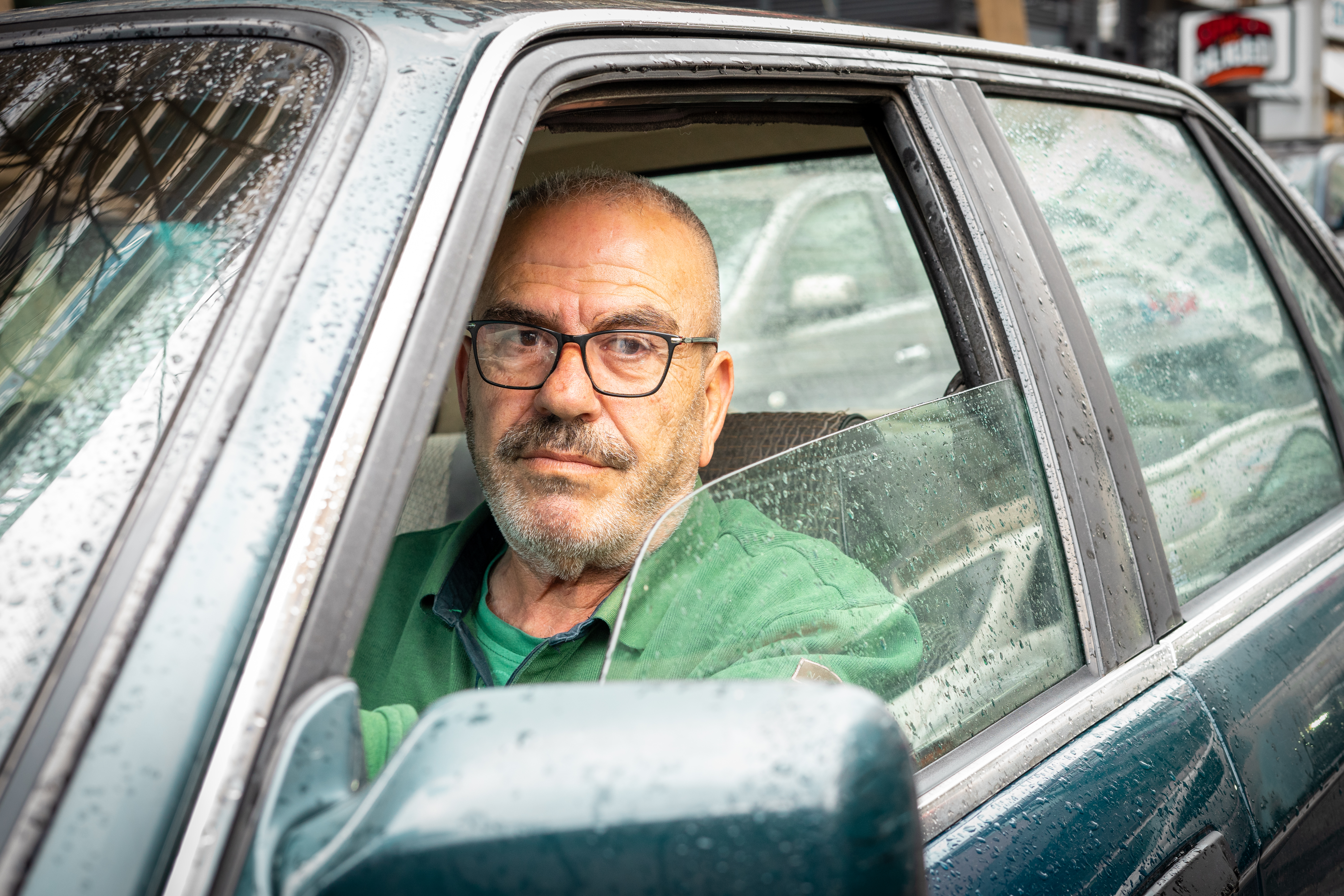 Man stares out of car window. 