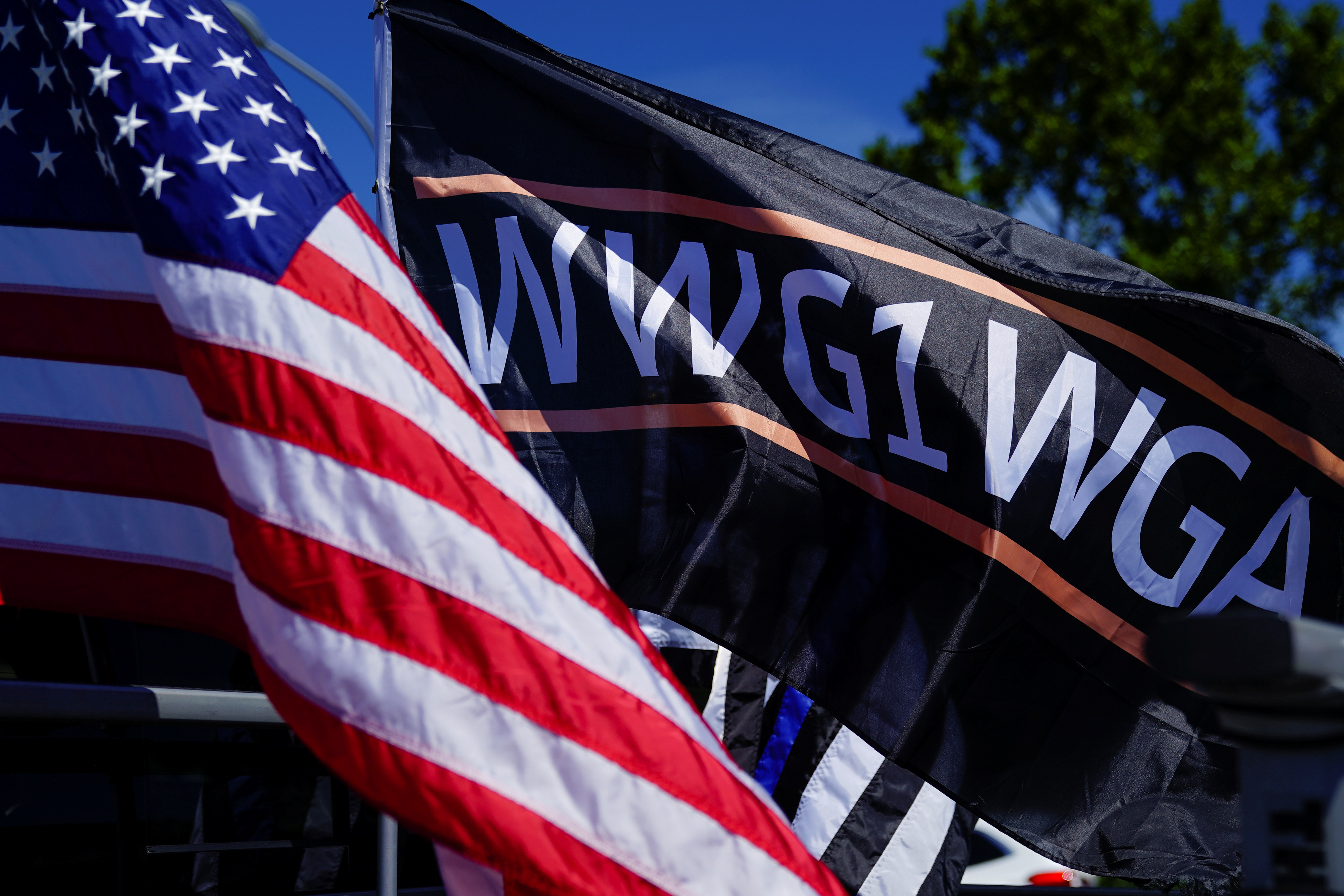An American flag and a flag reading WWG1WGA, a reference to the QAnon slogan are seen on a truck that participated in a caravan convoy in Adairsville, Georgia, U.S. September 5, 2020