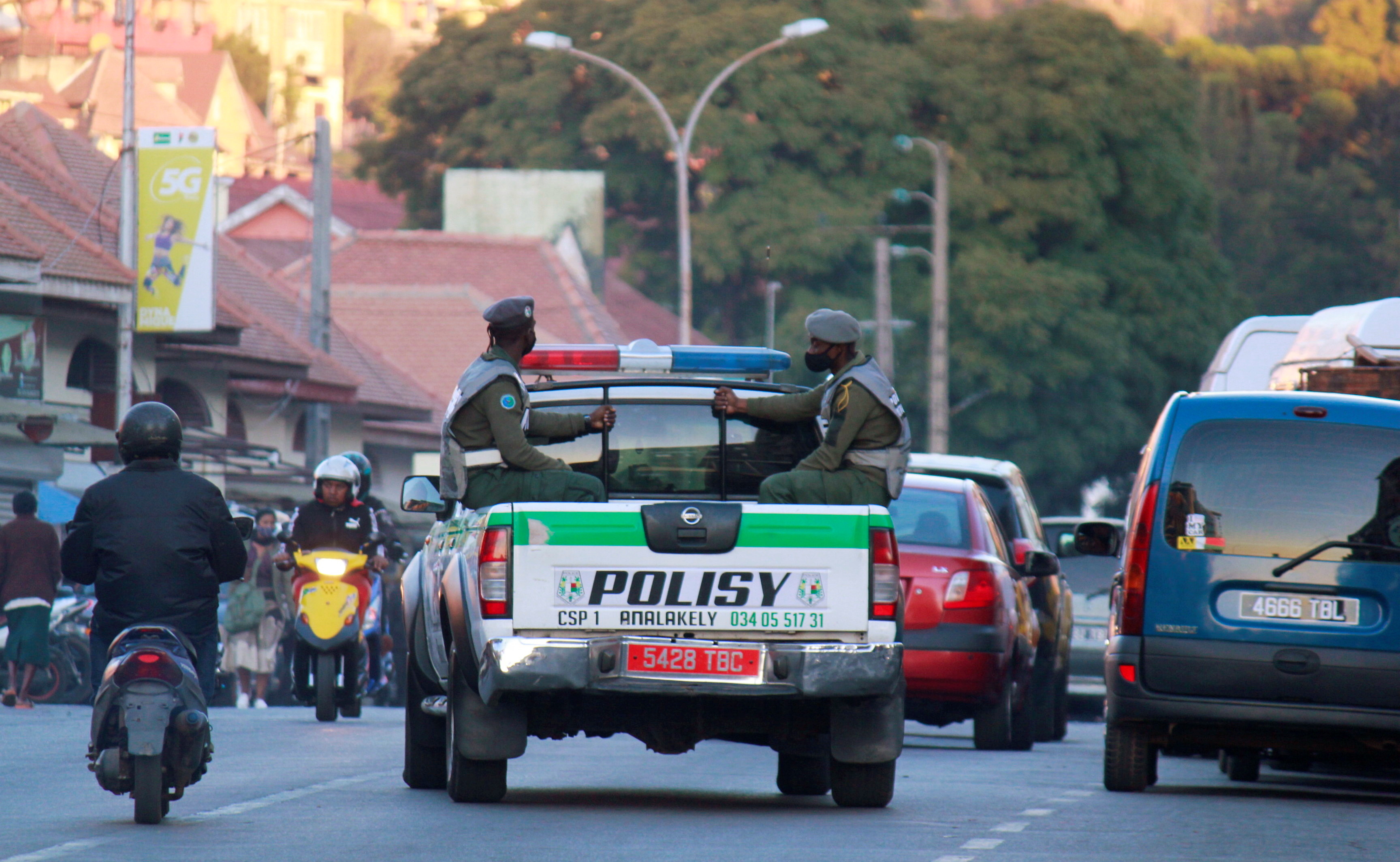 Police officers ride on their pickup truck as they patrol in downtown Antananarivo
