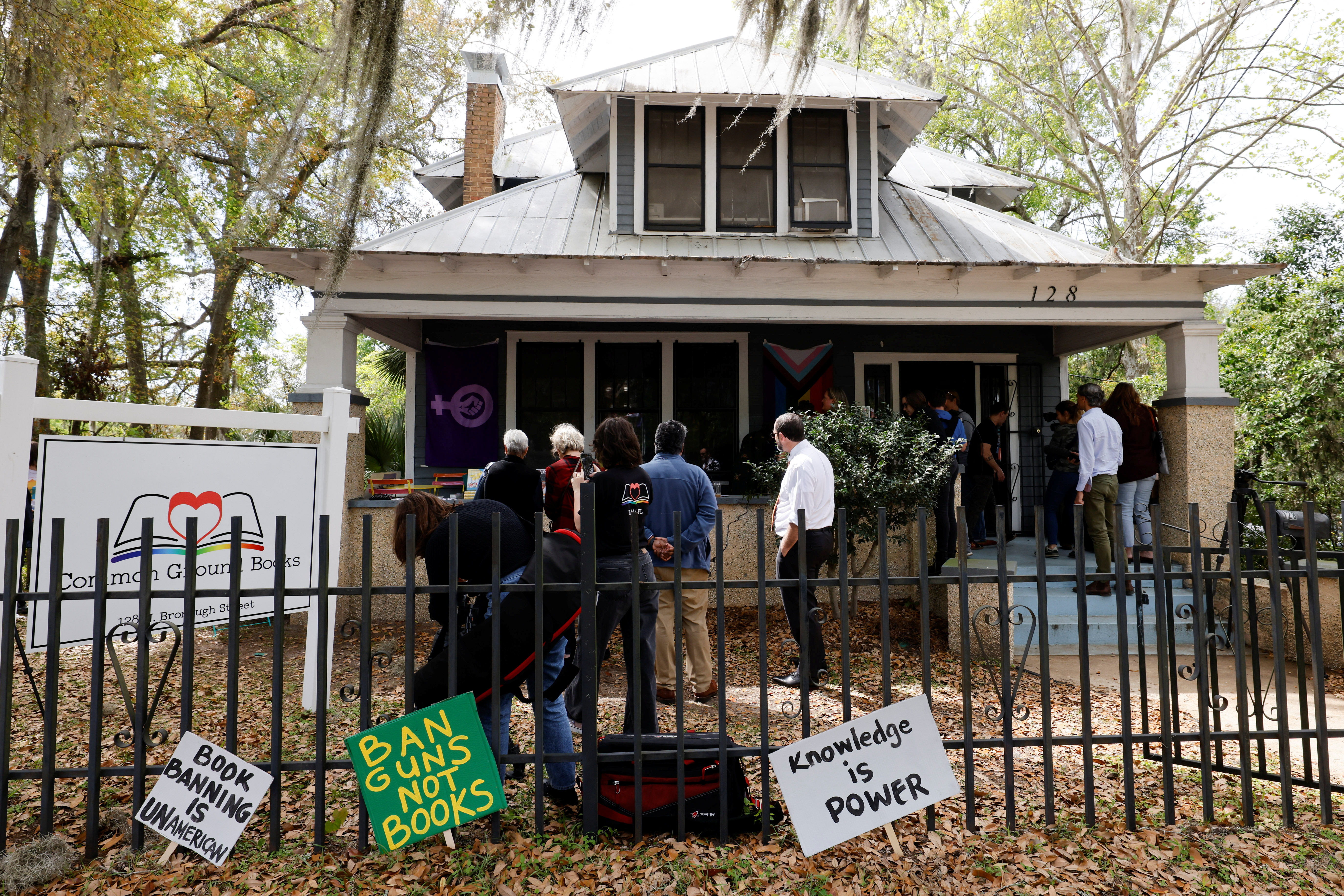 Participants and media gather for a read-in and rally against book bans