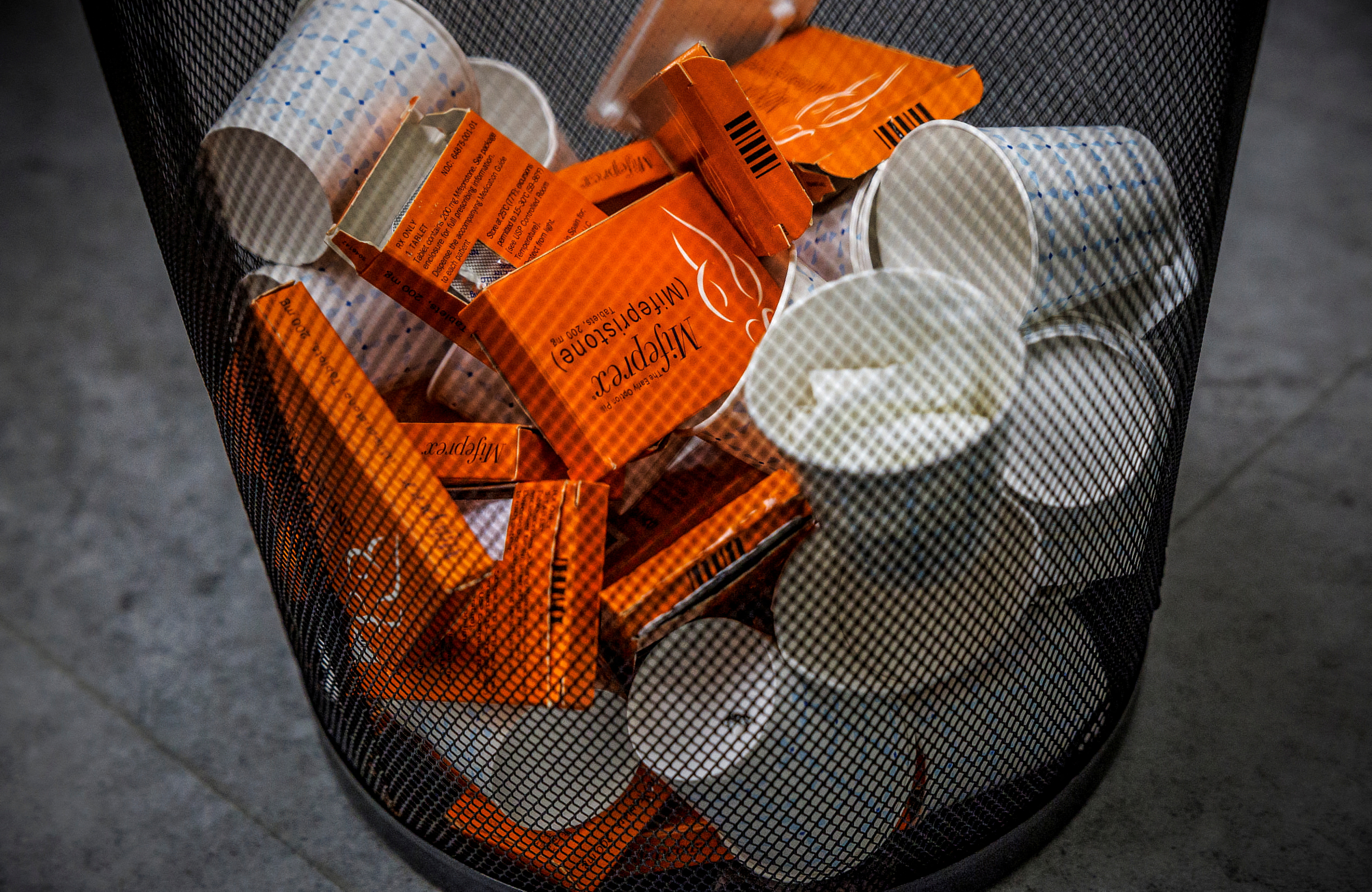 A waste bin with empty mifepristone packages