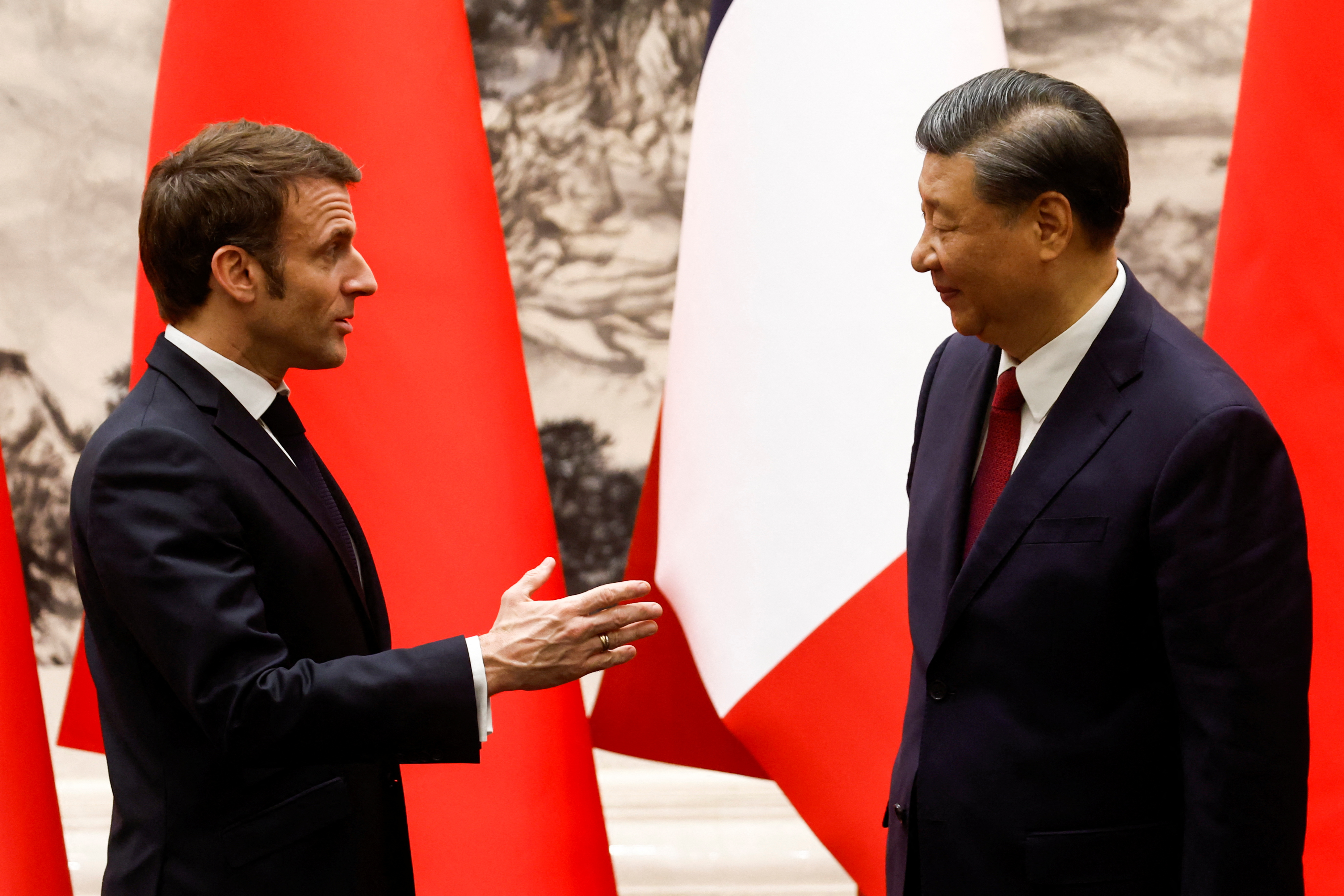 Chinese President Xi Jinping and French President Emmanuel Macron talk at the Great Hall of the People, in Beijing, China, April 6, 2023. REUTERS/Gonzalo Fuentes