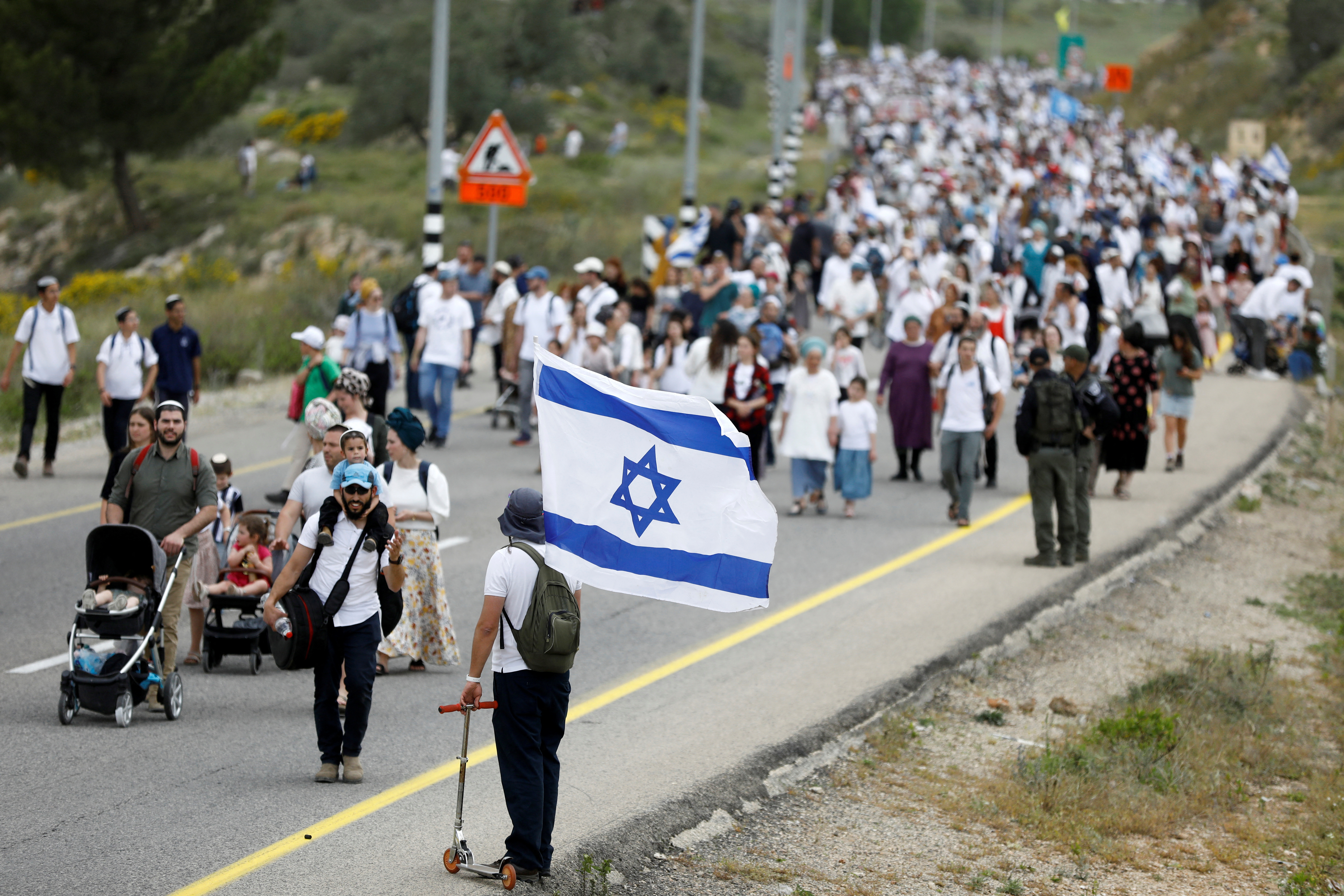 Israeli settlers hold a protest march