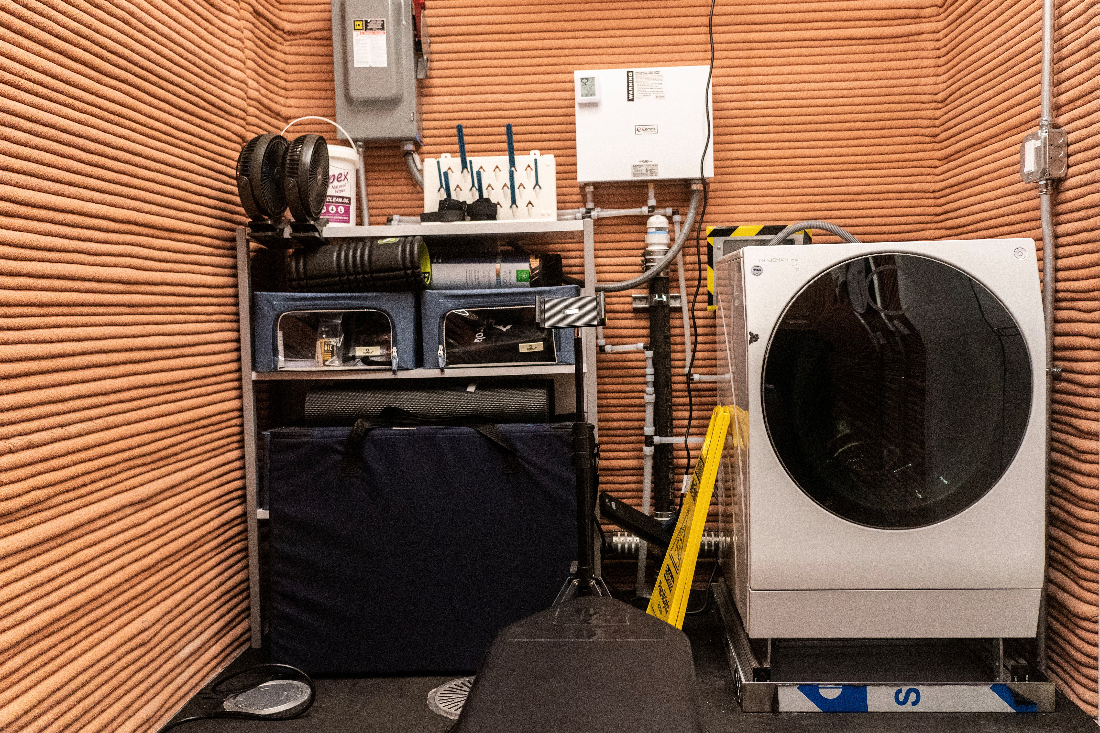A washing machine and exercise equipments are seen inside the Mars Dune Alpha